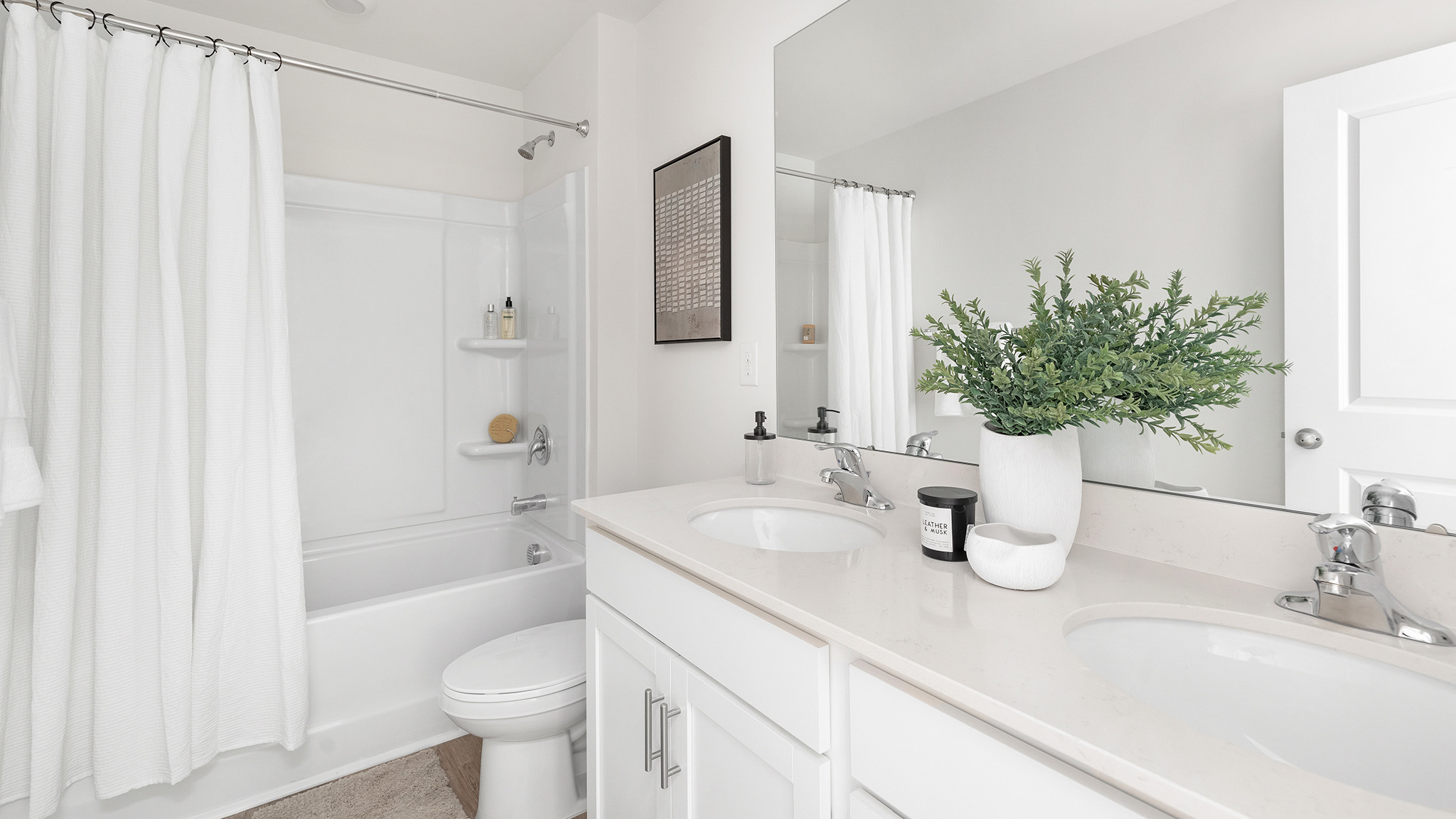 Bathroom with double sinks and bathtub