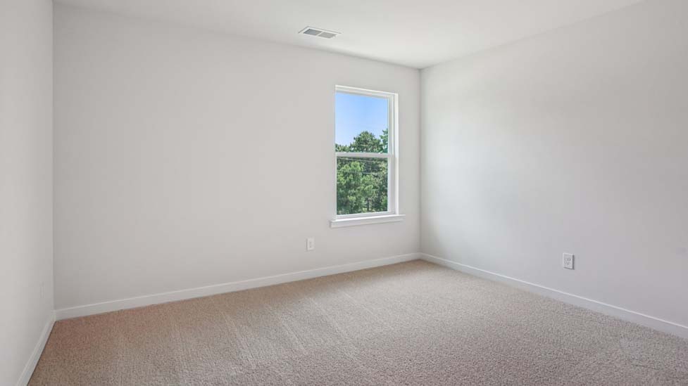 Carpeted bedroom with large windows