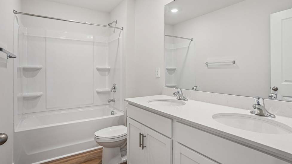 Bathroom with double sinks and bathtub