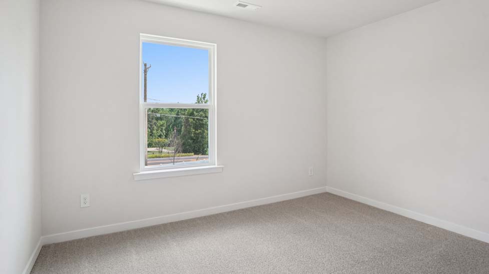Carpeted bedroom with large windows