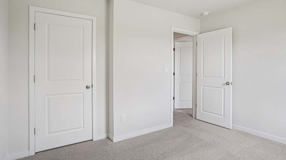 Carpeted bedroom with large windows