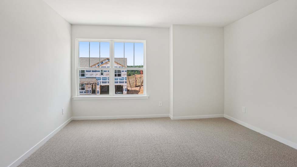 Carpeted bedroom with large windows