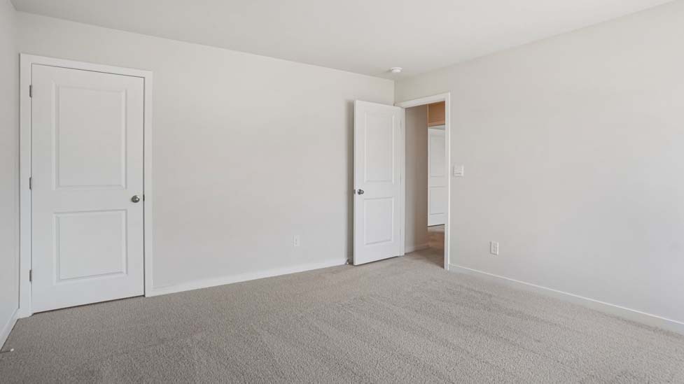 Carpeted bedroom with large windows