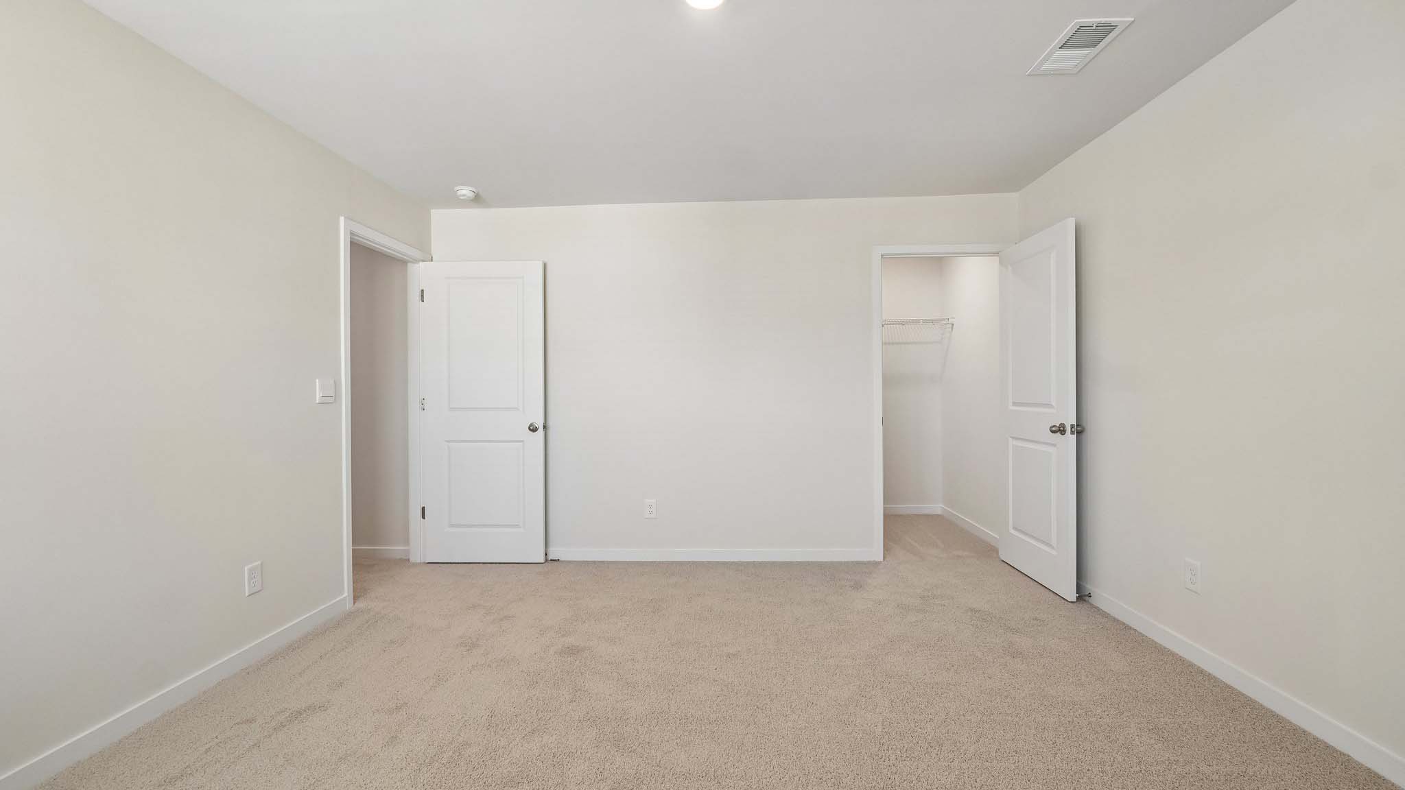 Carpeted bedroom with large windows