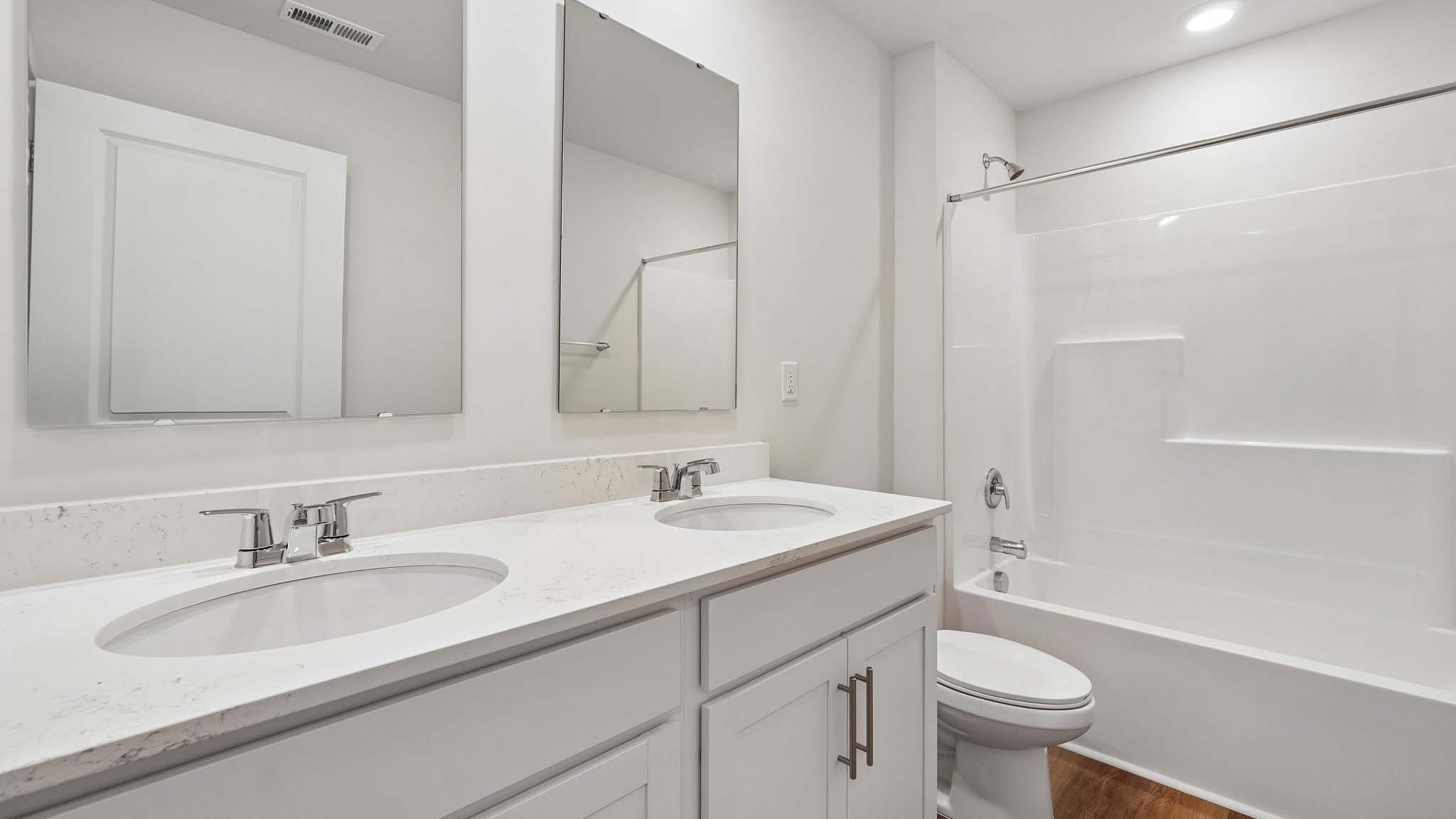 Bathroom with white cabinets and tub shower