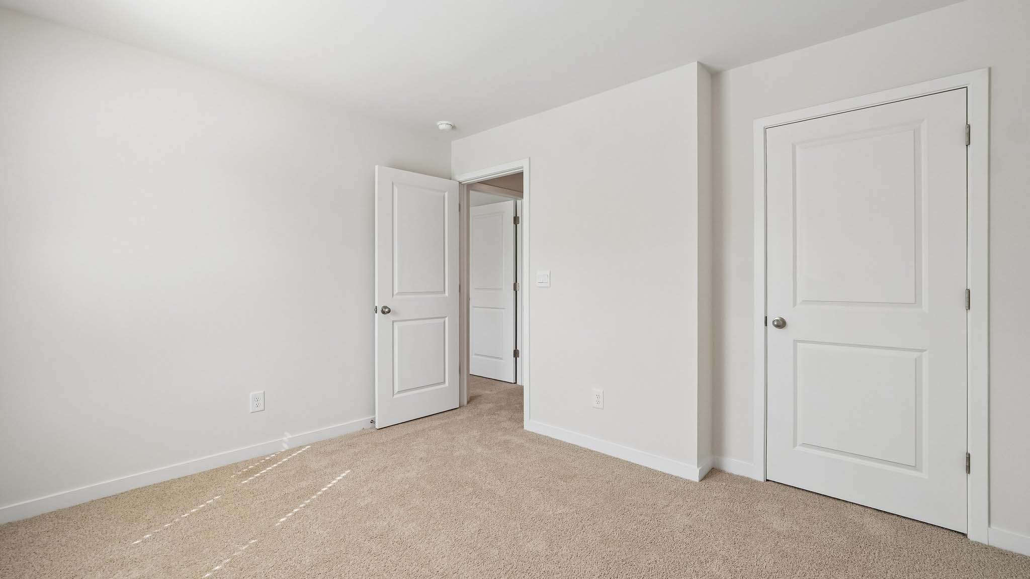 Carpeted bedroom with large windows