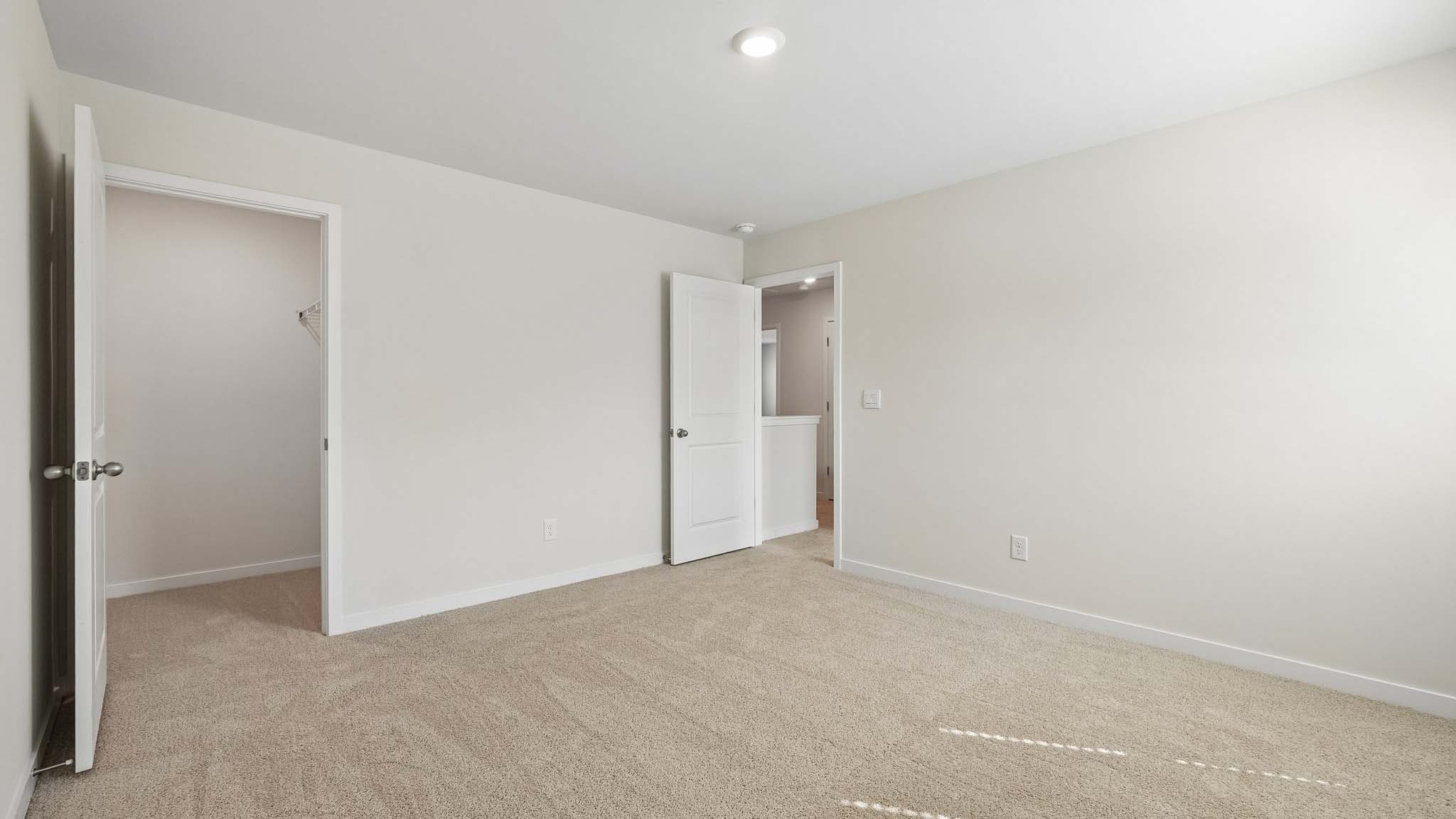 Carpeted bedroom with large windows