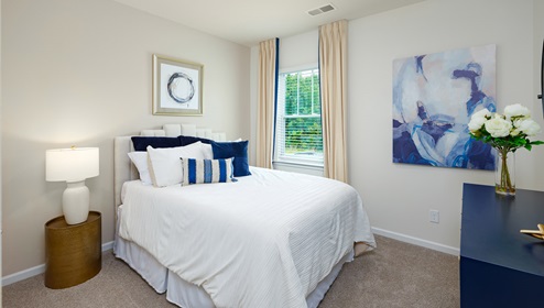 carpeted bedroom with large window