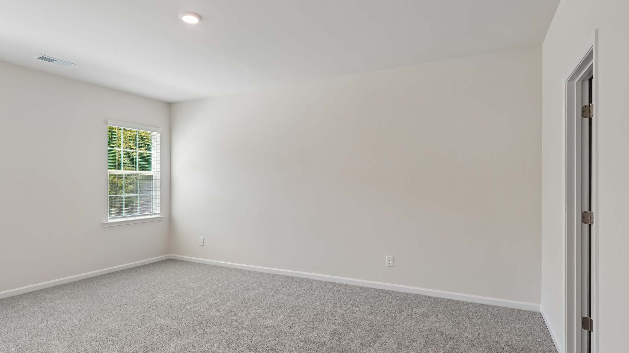 Carpeted bedroom with two windows