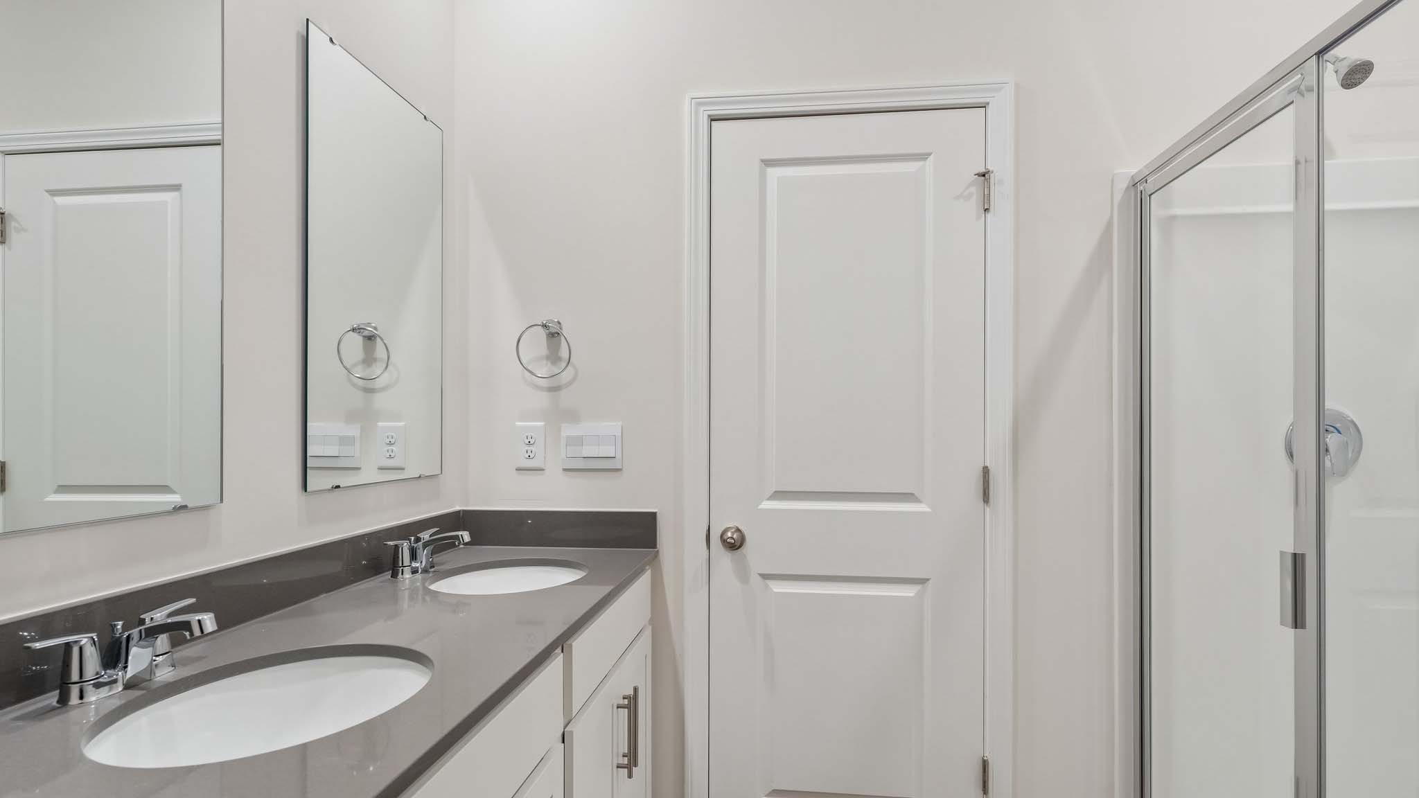 Primary bathroom with double sinks, and bathtub