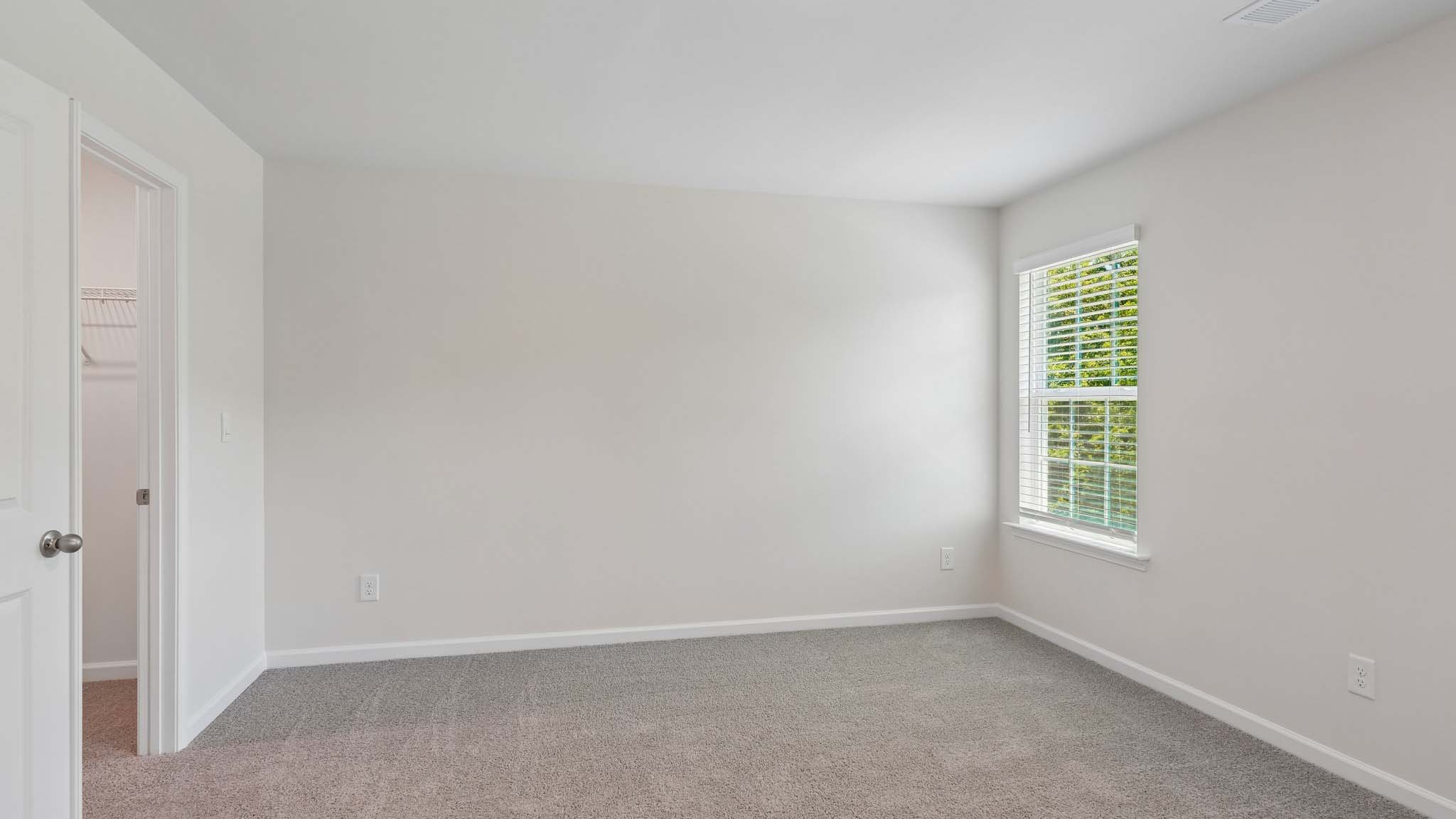 Carpeted bedroom with two windows