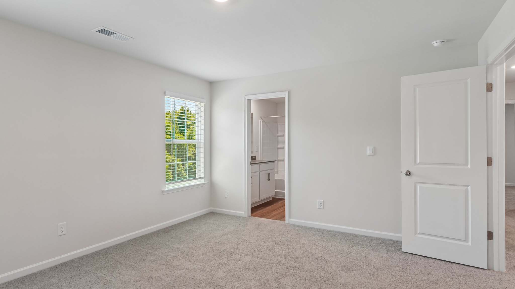 Carpeted bedroom with two windows