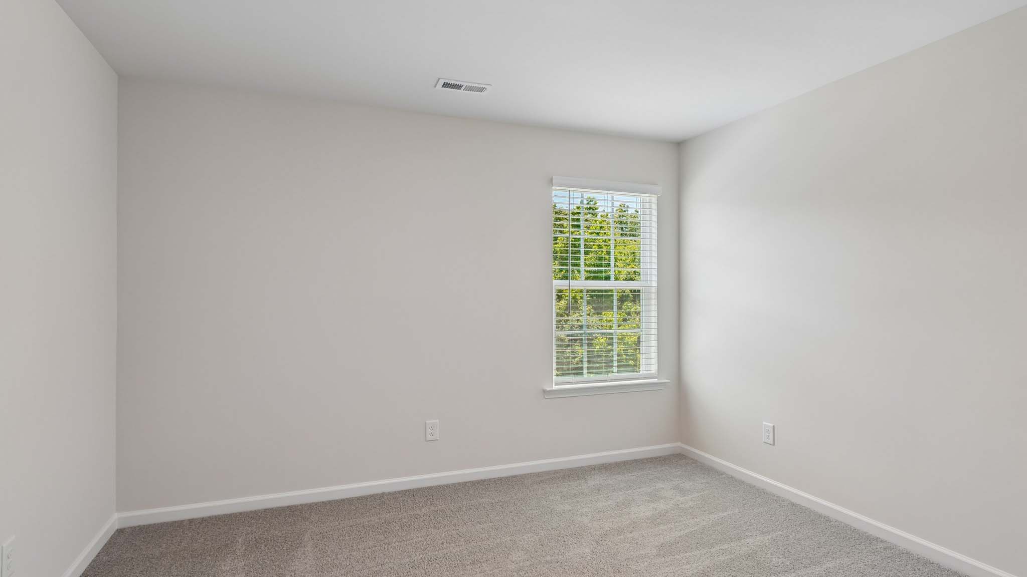 Carpeted bedroom with two windows