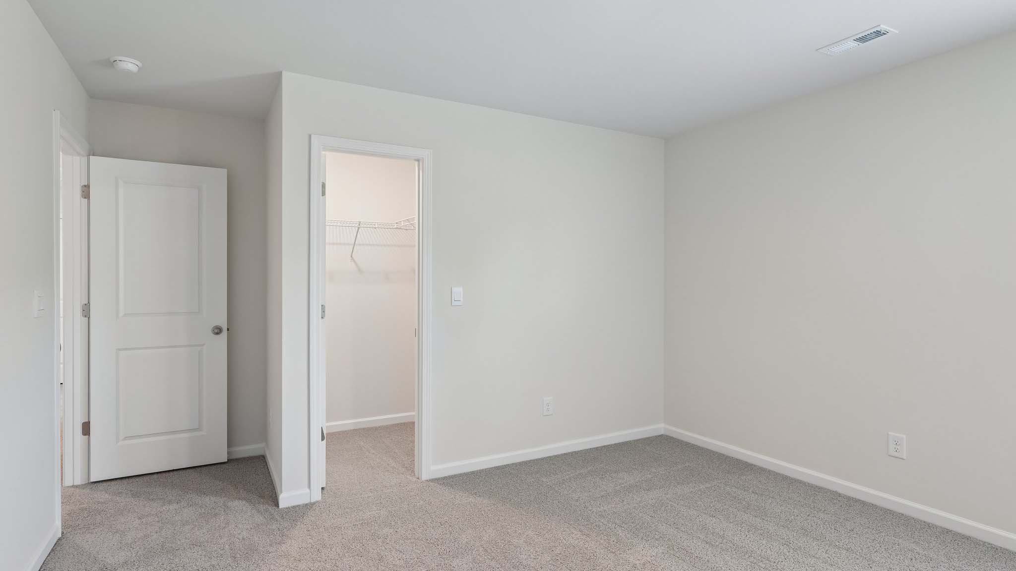 Carpeted bedroom with two windows
