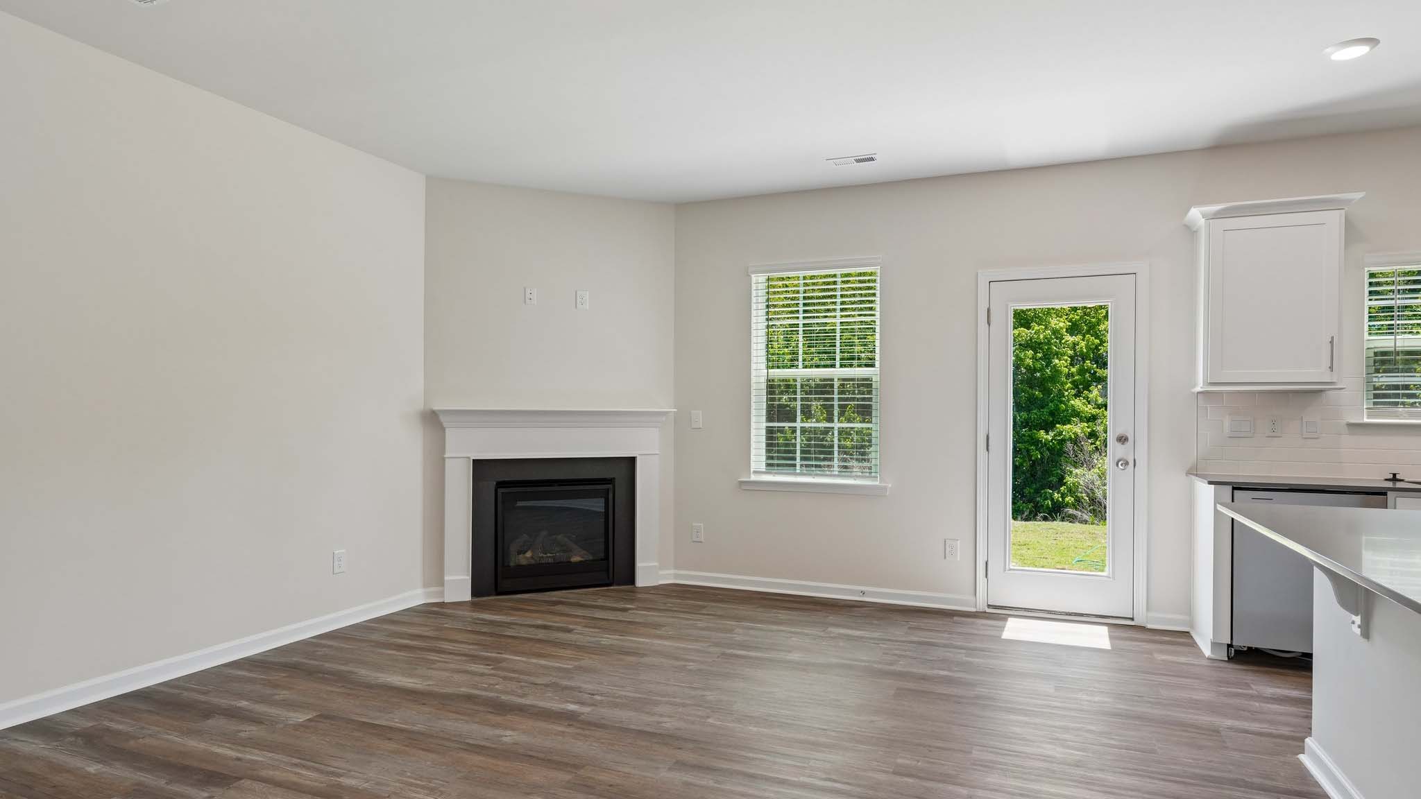 Open family room with fireplace and windows on either side