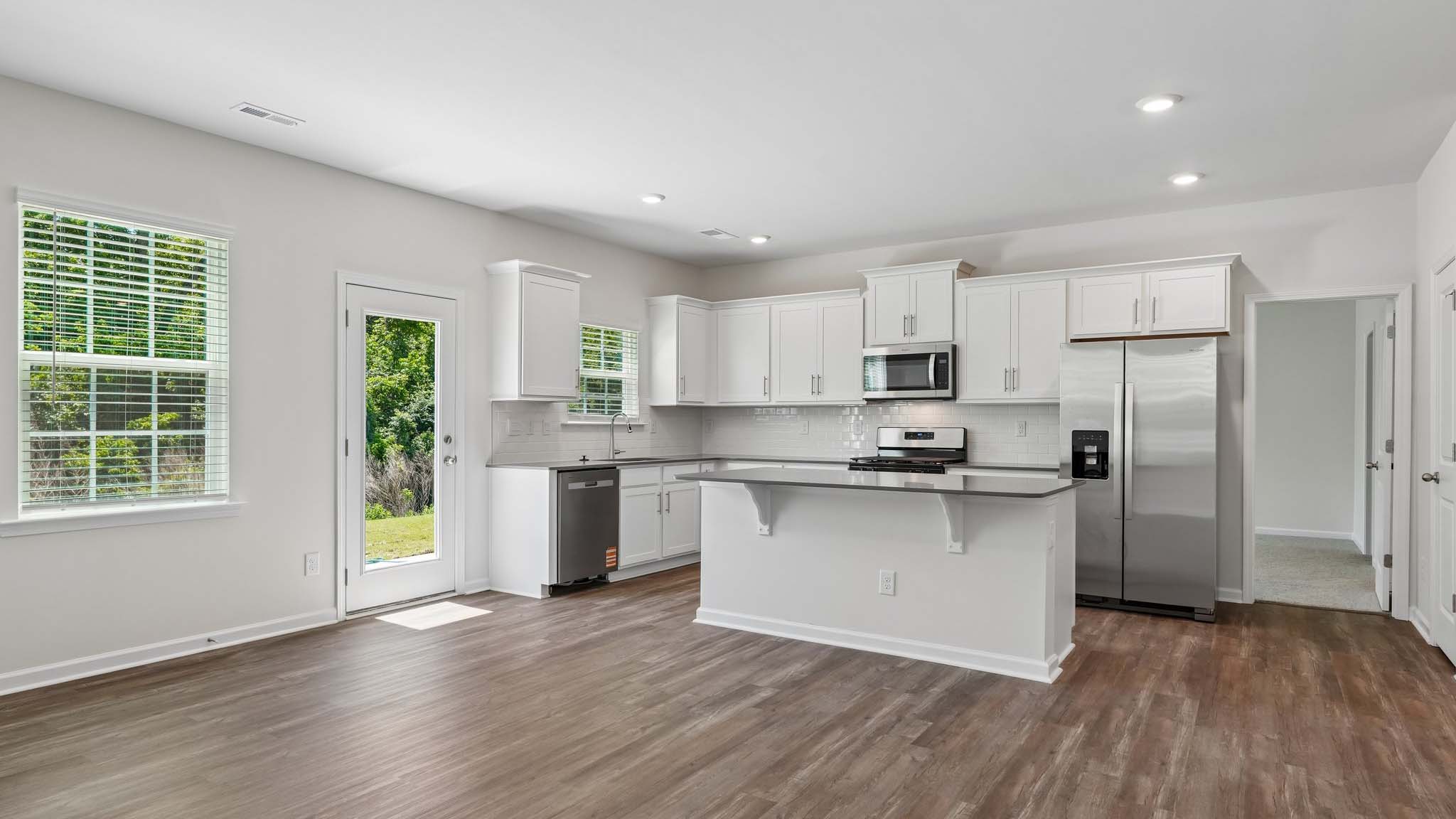 Kitchen and island with white counters and cabinets