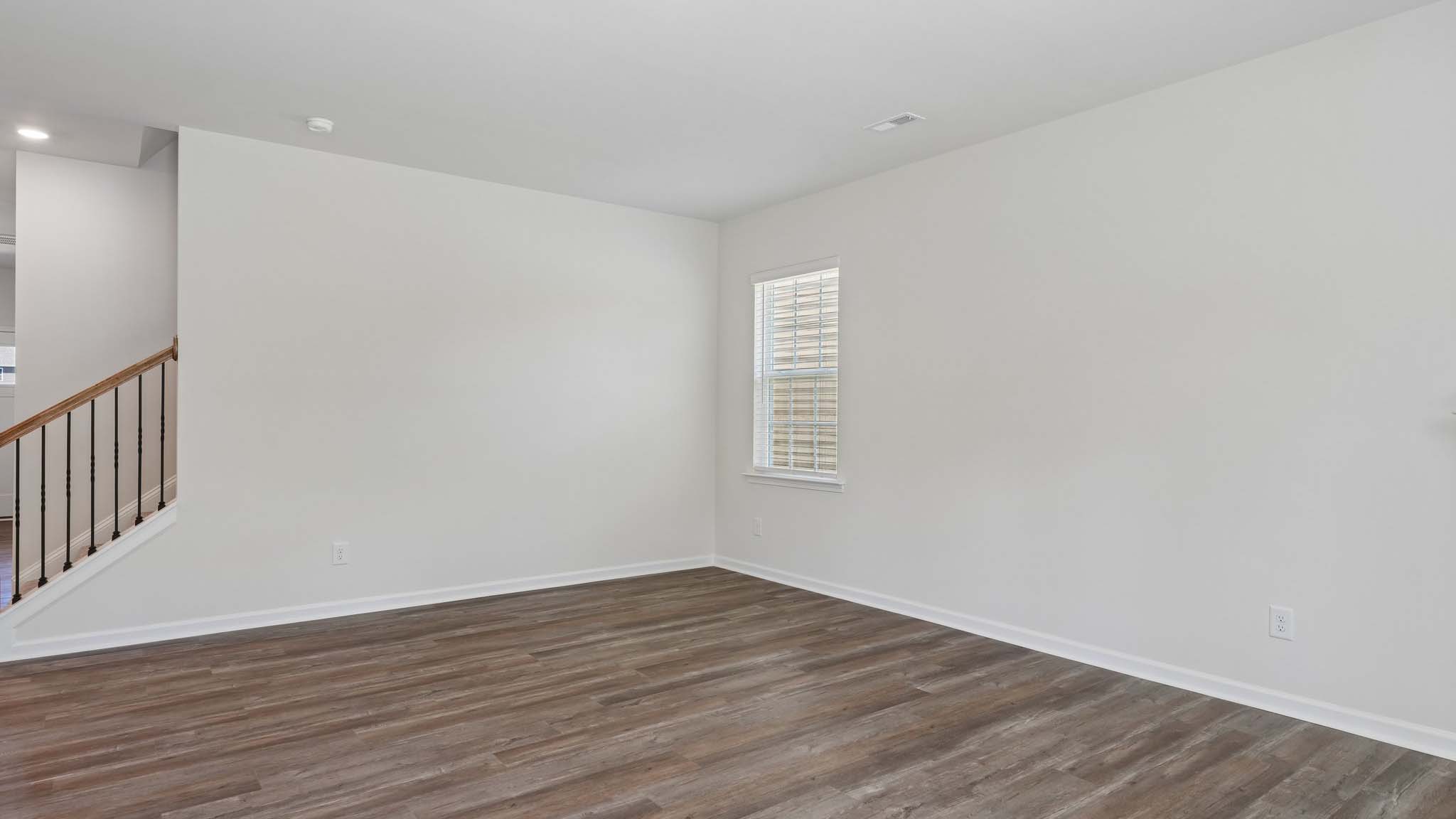 Open family room with fireplace and windows on either side