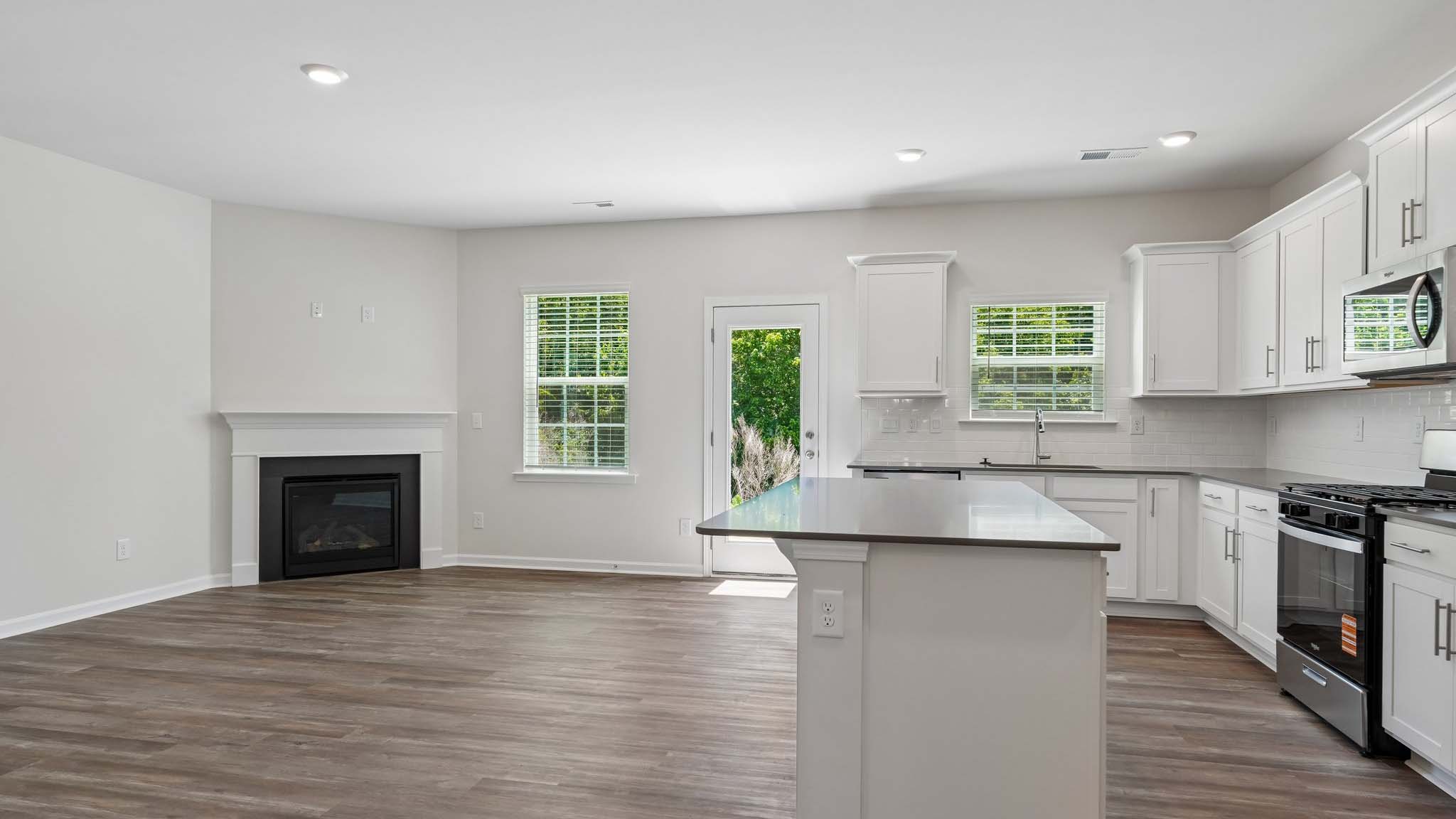 Open family room with fireplace and windows on either side