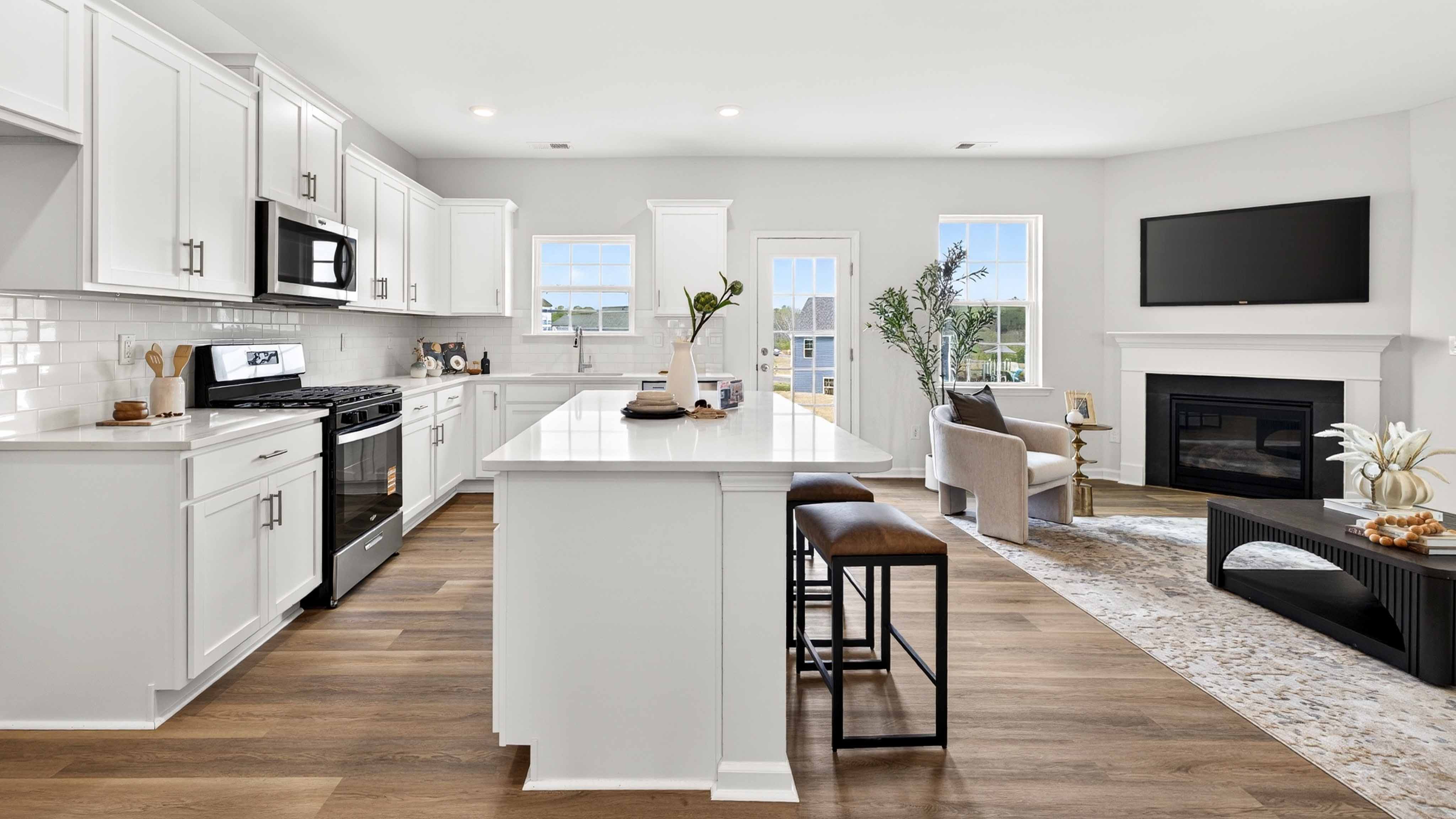 Kitchen and island with white counters and cabinets