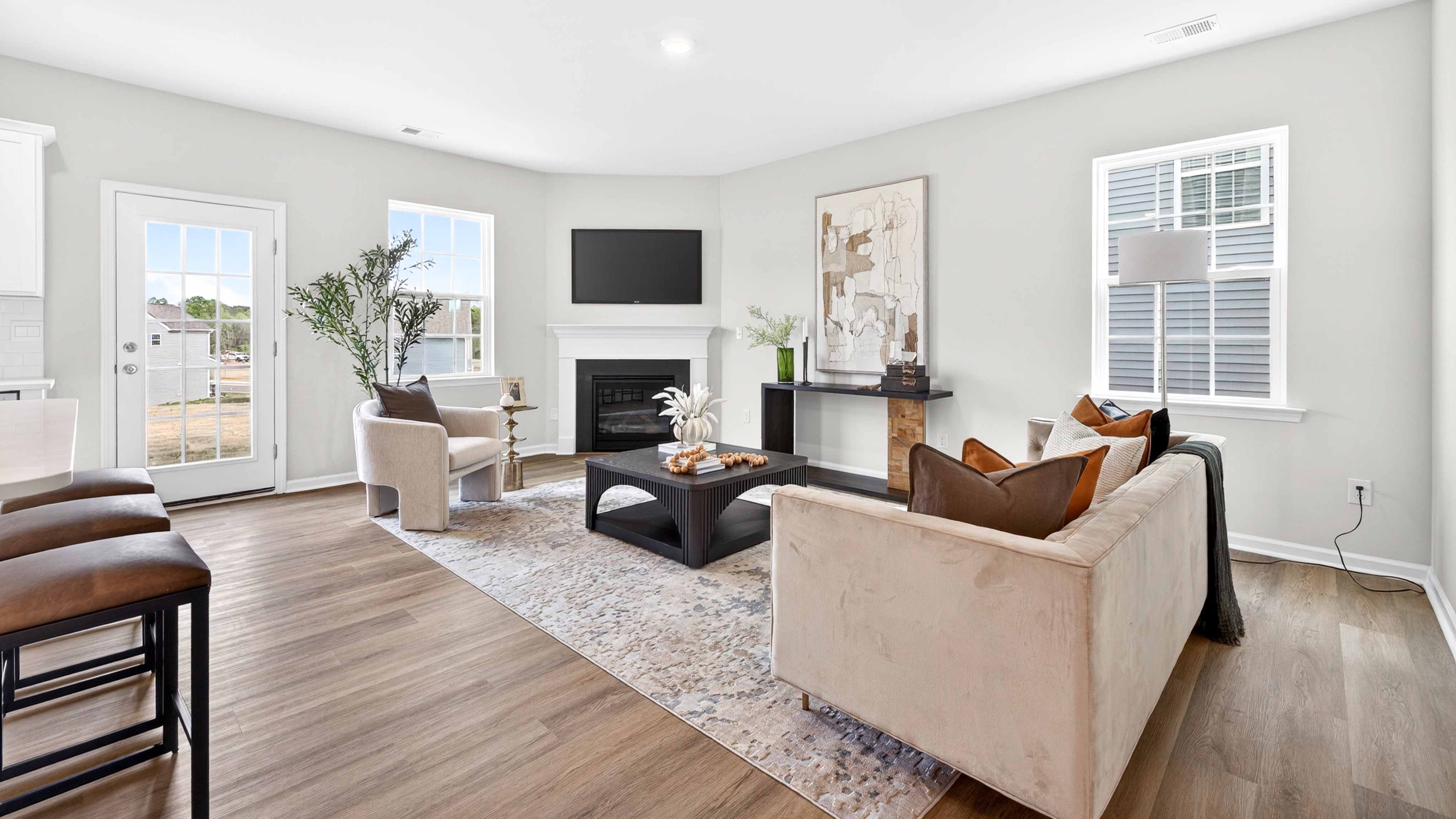 Open family room with fireplace and windows on either side