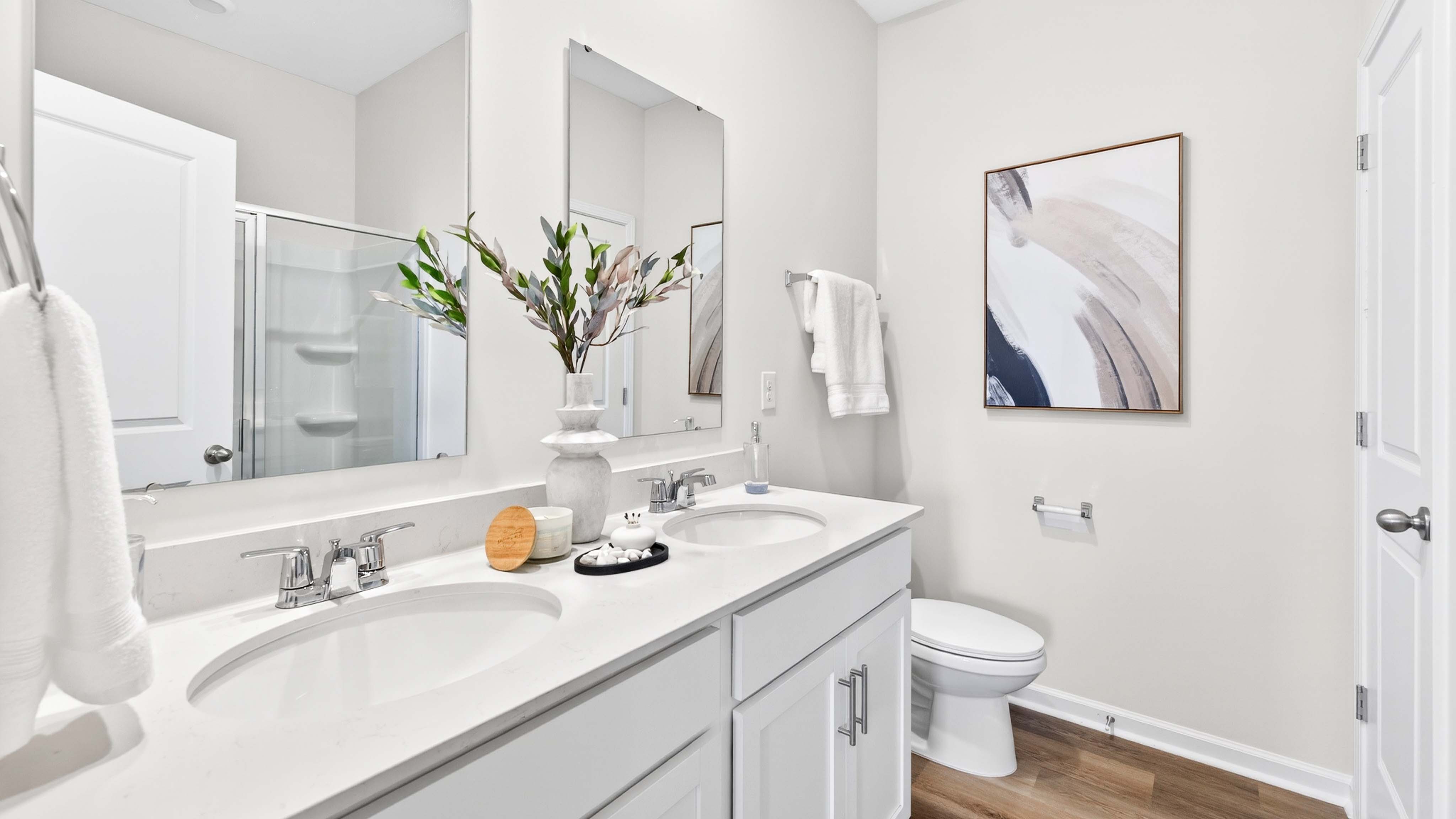 Primary bathroom with double sinks, and bathtub
