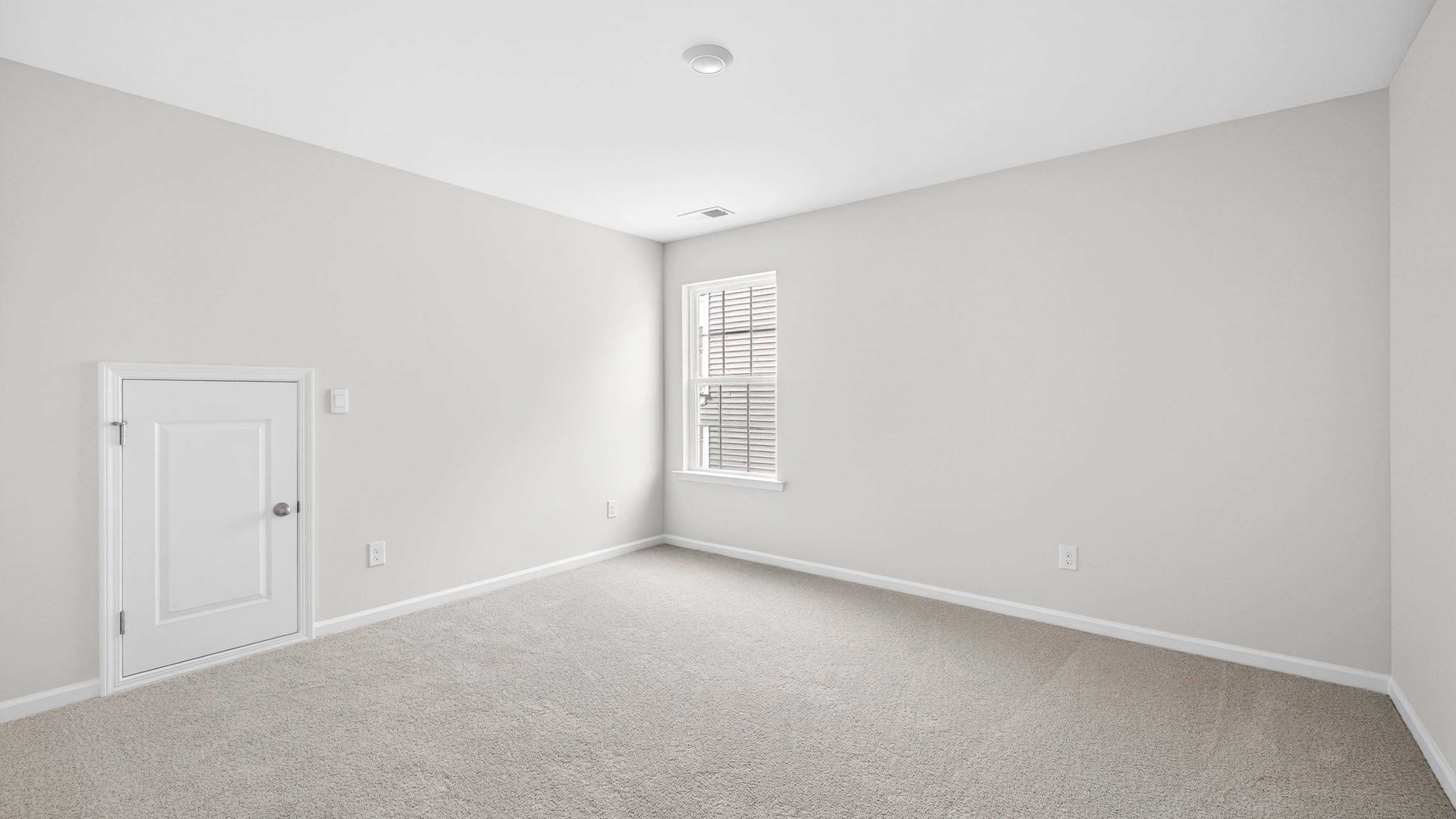 Carpeted bedroom with windows