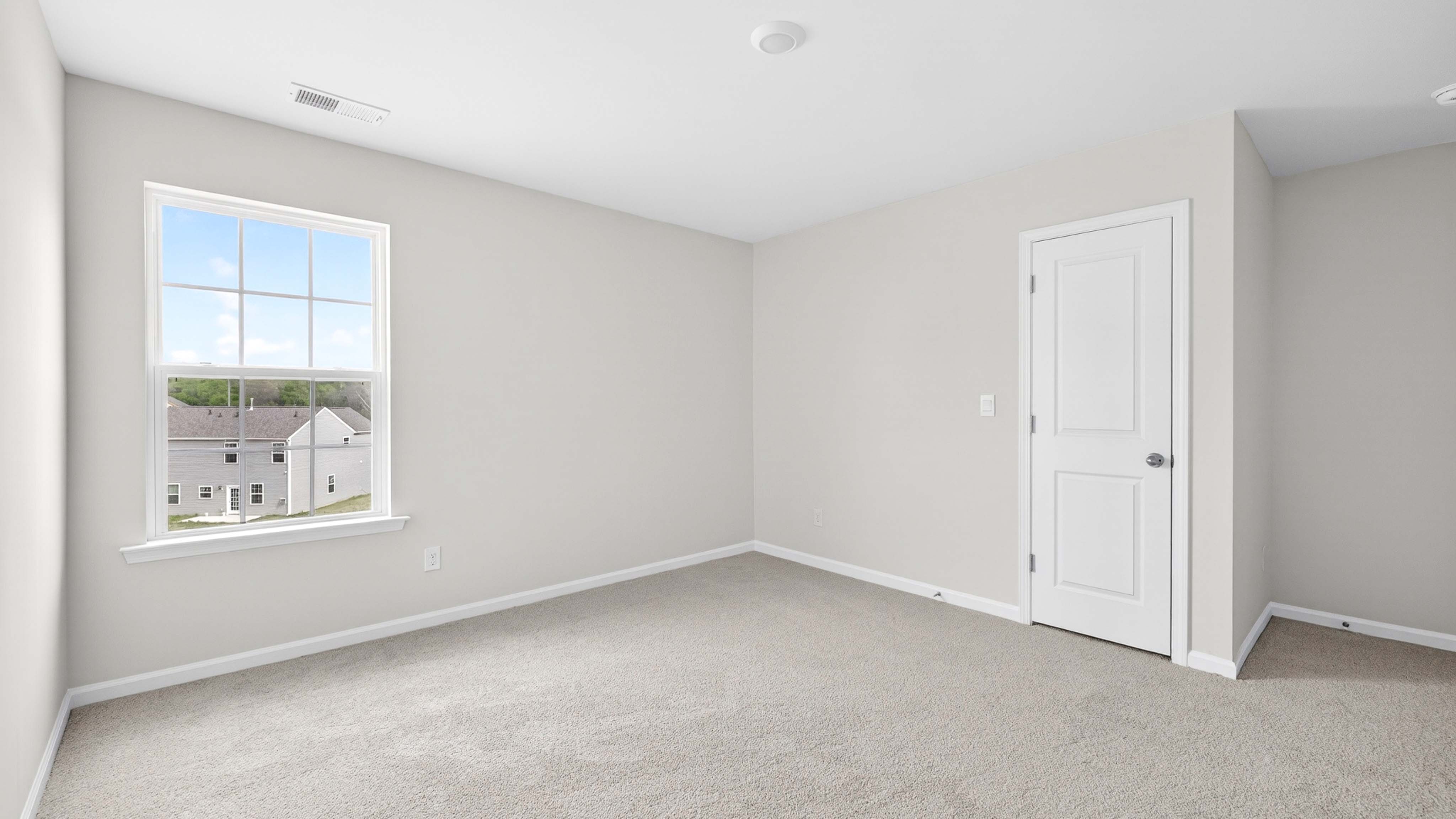 Carpeted bedroom with windows