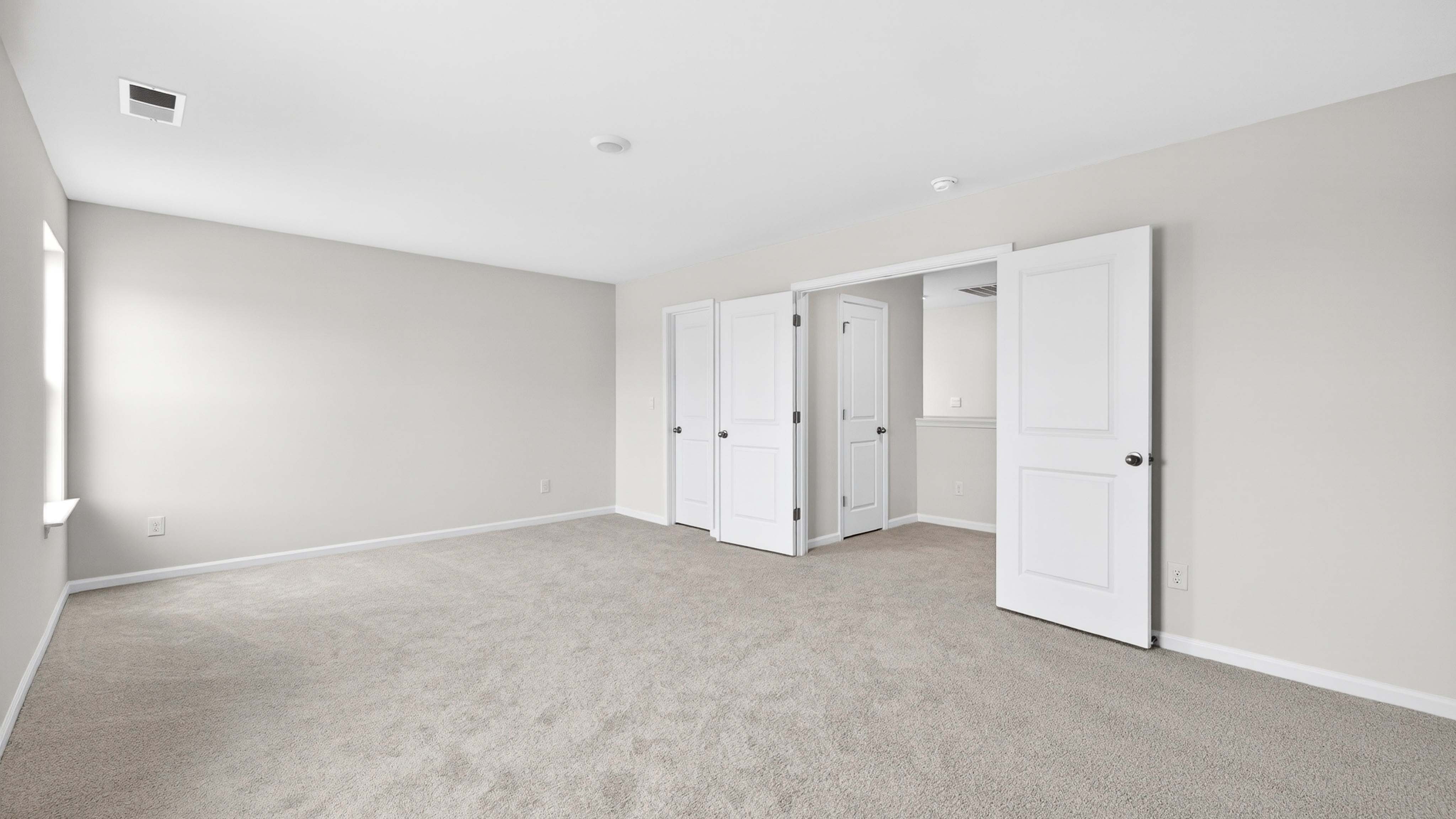 Carpeted bedroom with windows