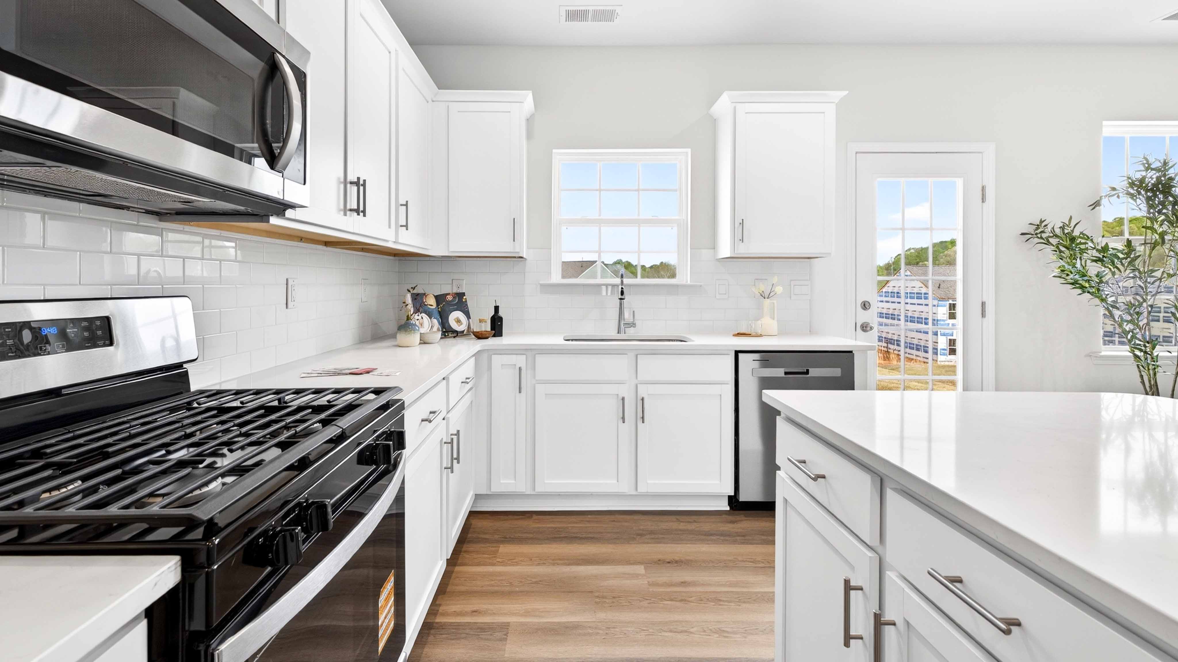 Kitchen and island with white counters and cabinets