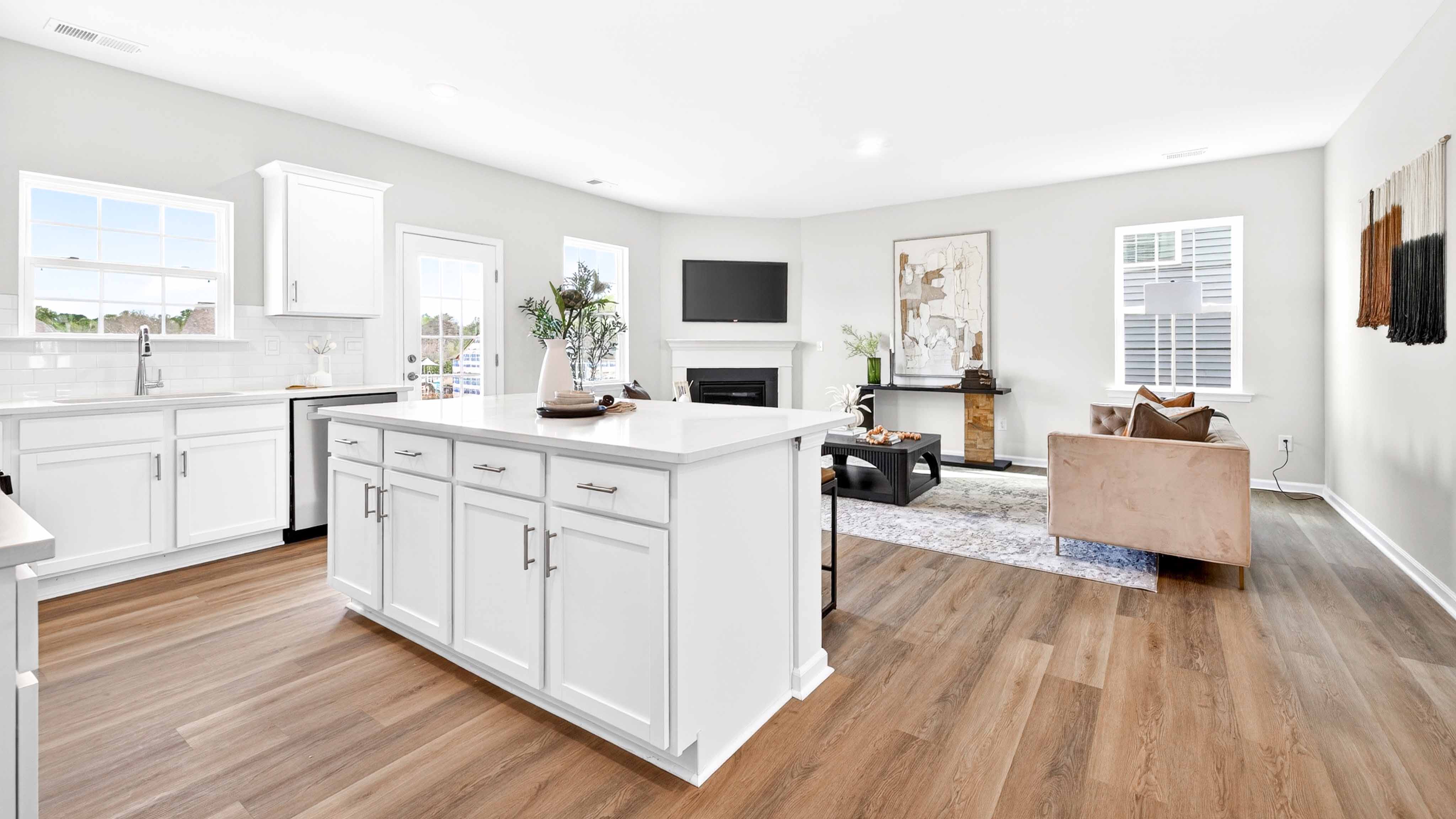 Kitchen and island with white counters and cabinets