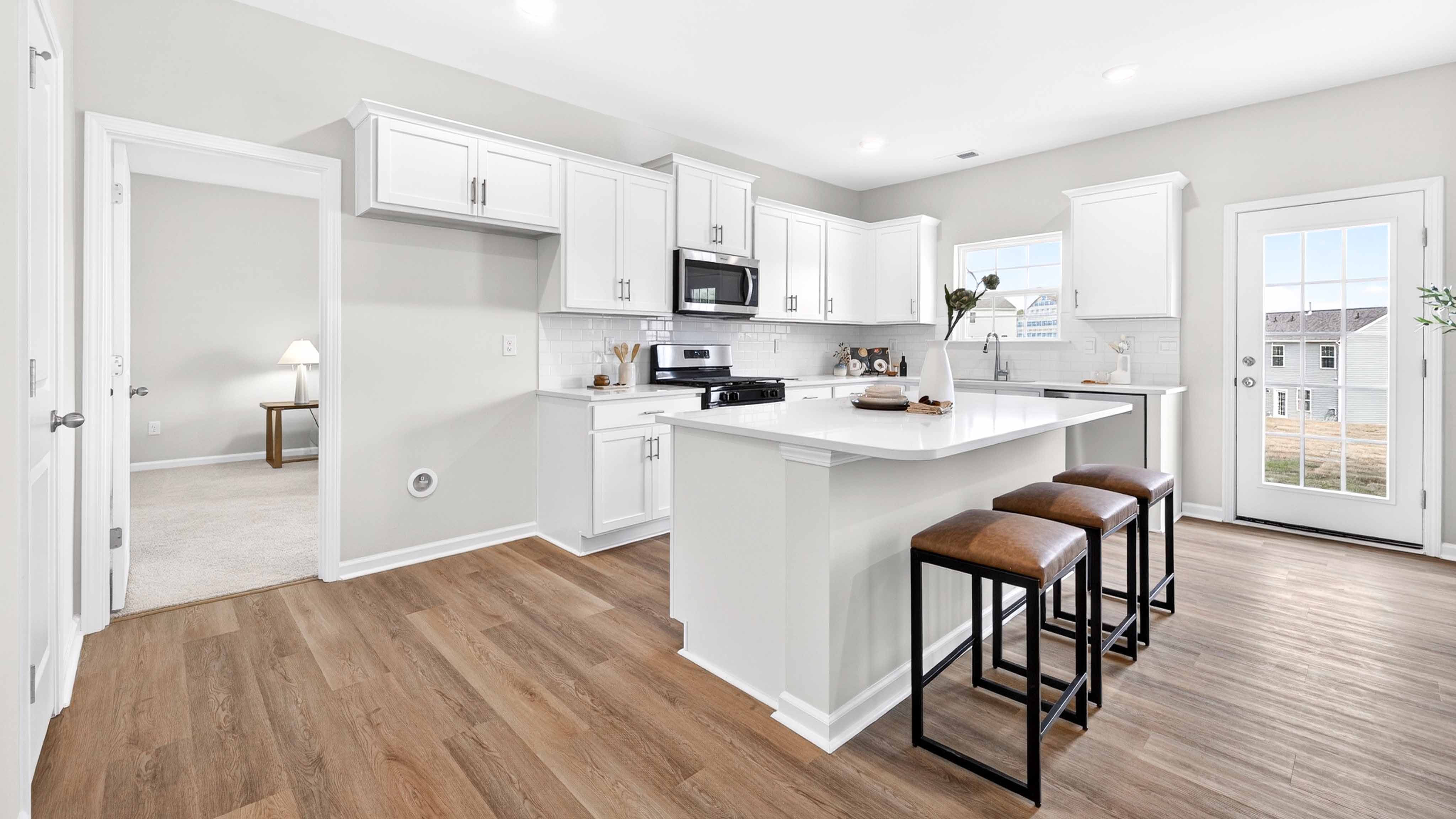 Kitchen and island with white counters and cabinets