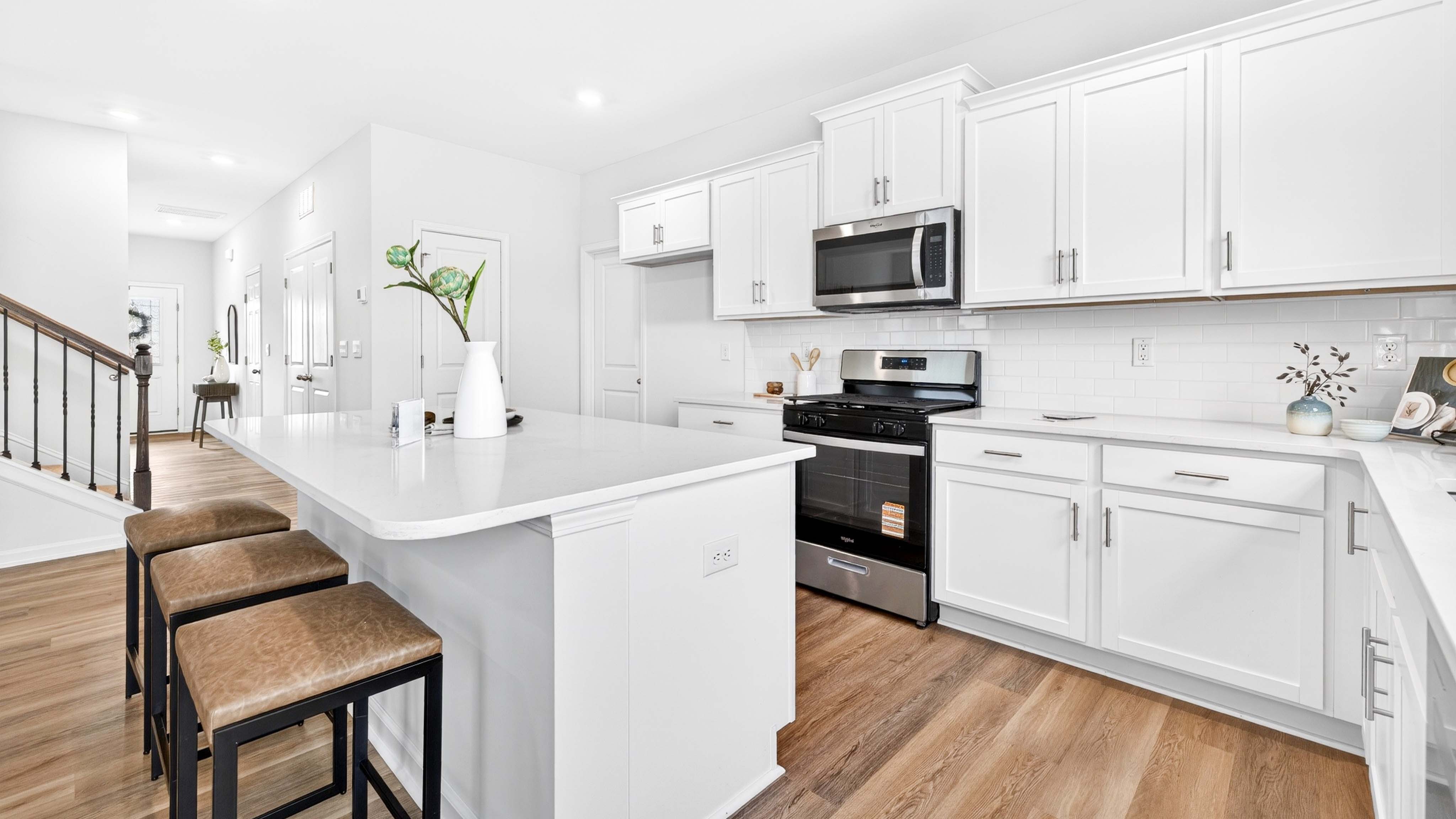 Kitchen and island with white counters and cabinets