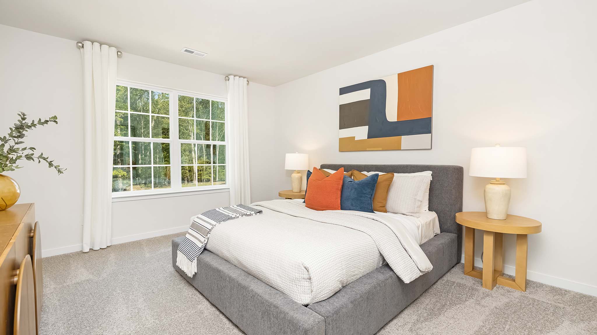 Carpeted bedroom with large window