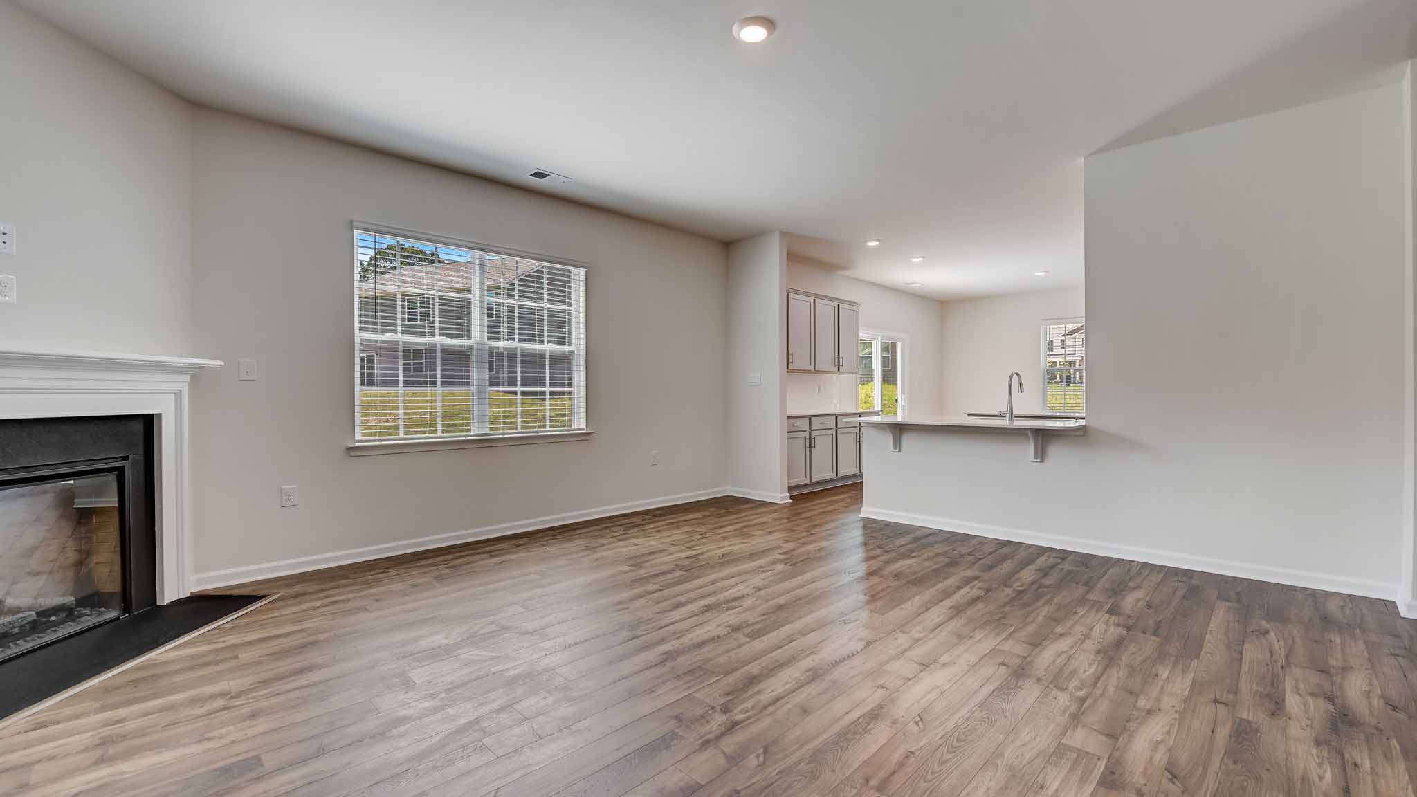 Open family room with windows and fireplace
