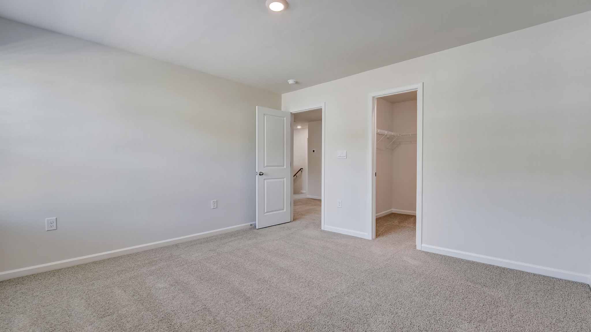 Carpeted bedroom with large window
