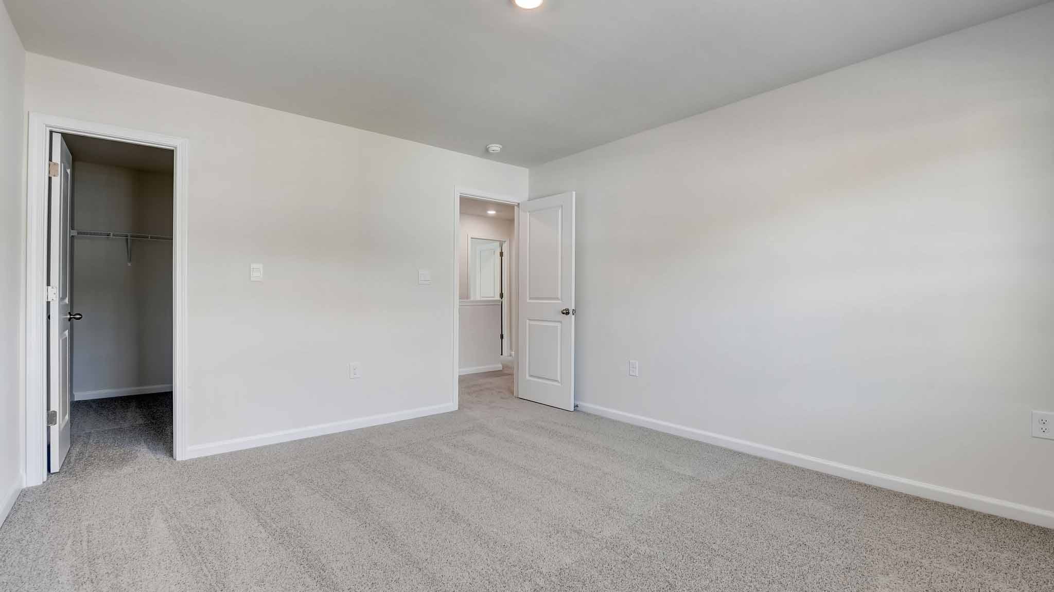 Carpeted bedroom with large window