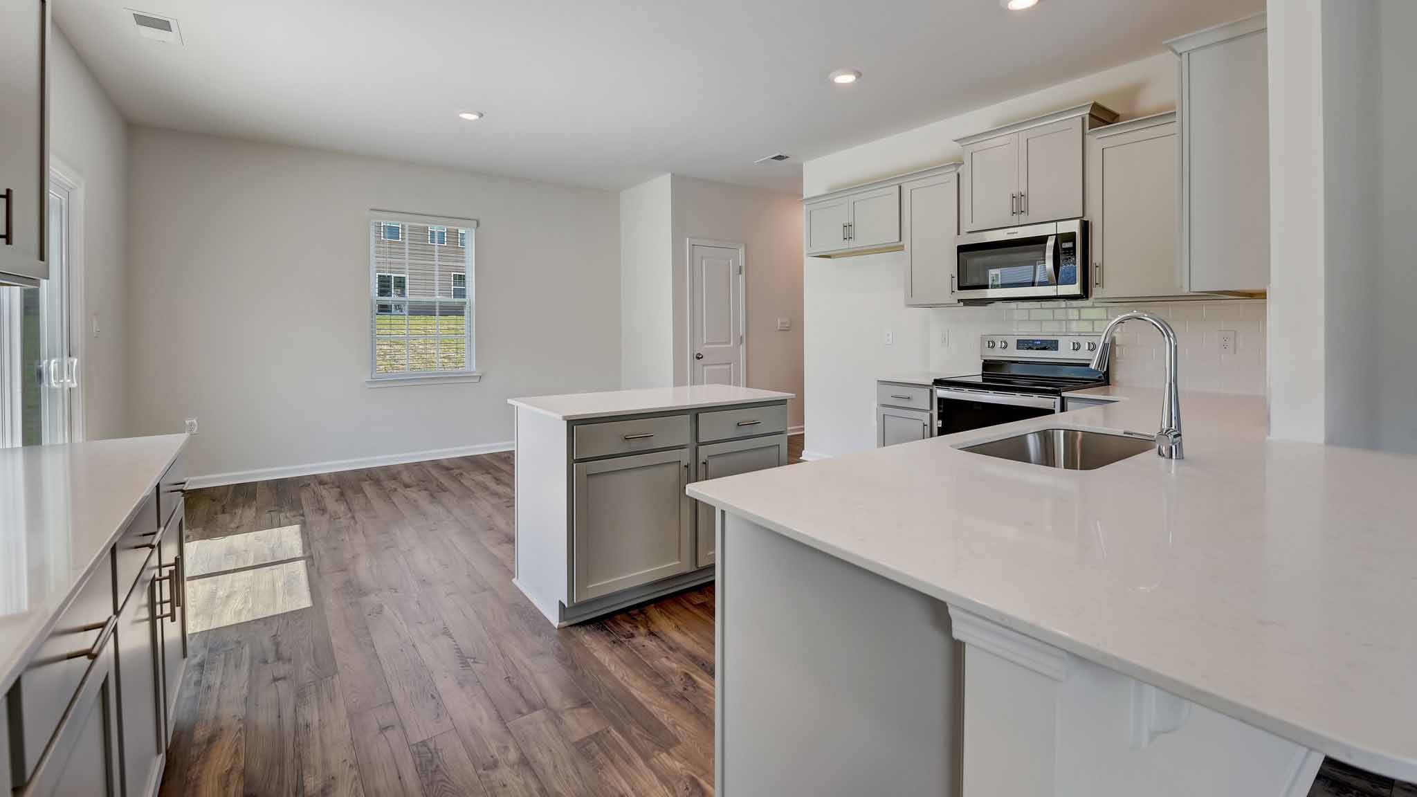 Kitchen and island with white cabinets