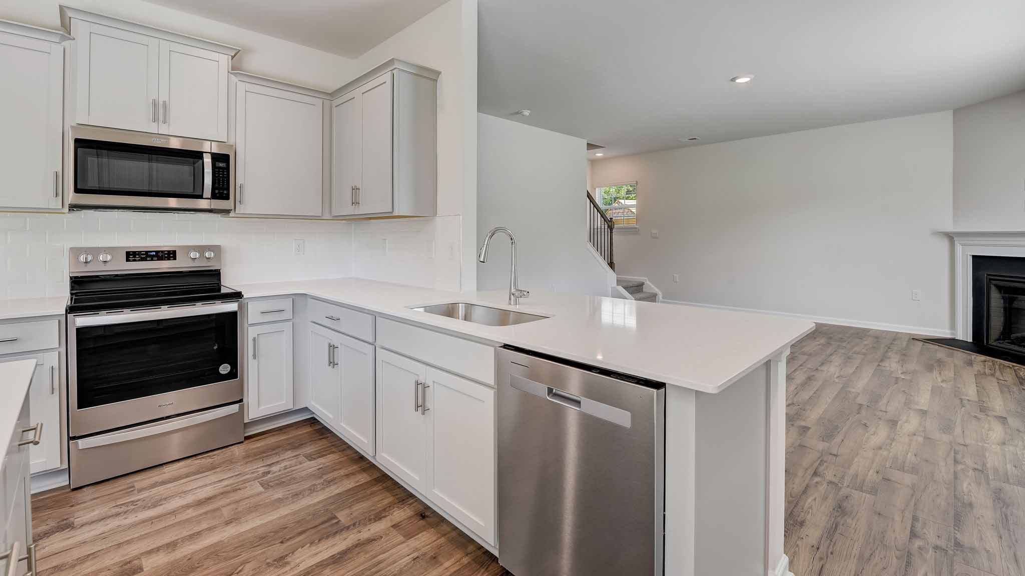 Kitchen and island with white cabinets