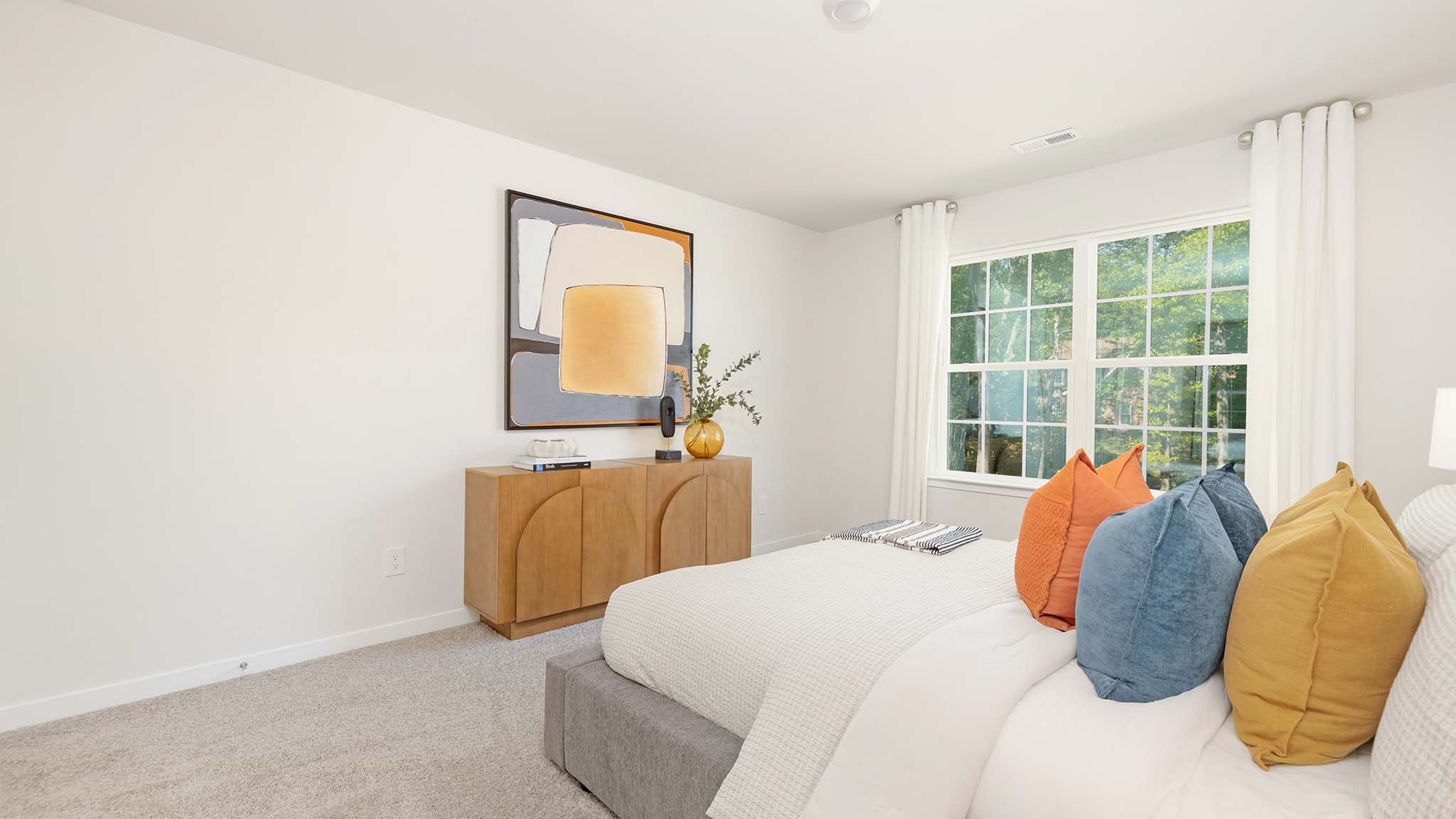 Carpeted bedroom with large window
