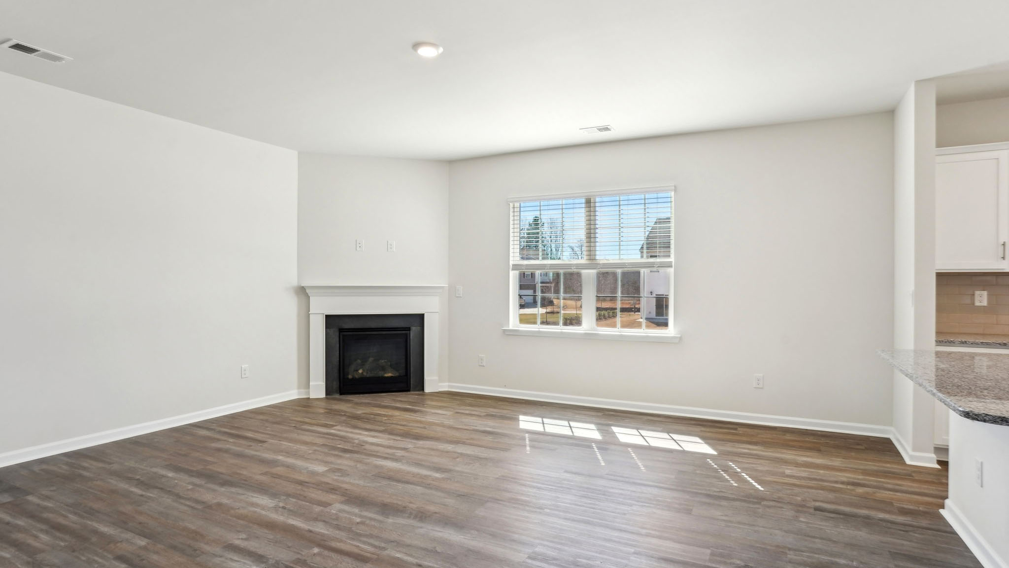 Open family room with windows and fireplace