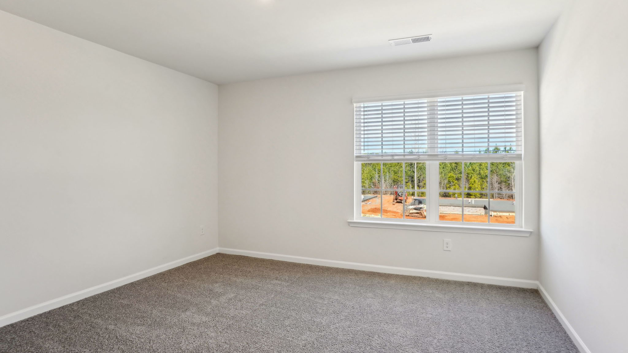 Carpeted bedroom with large window