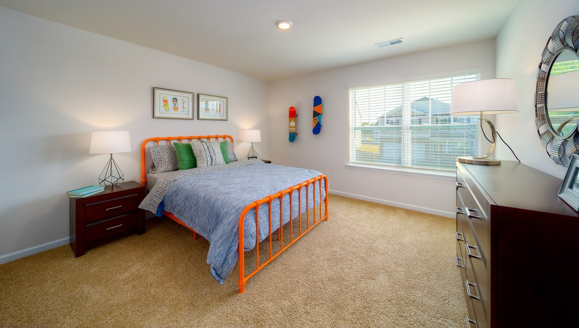 Carpeted bedroom with large window