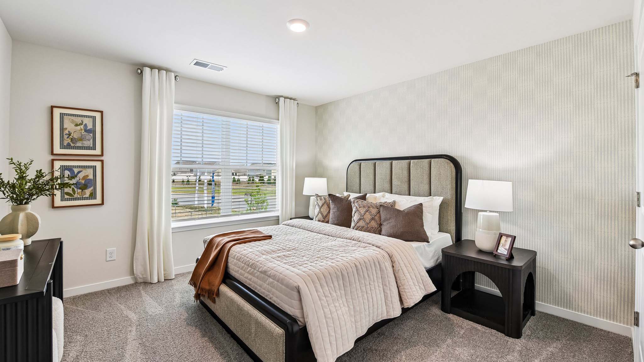 Carpeted bedroom with windows