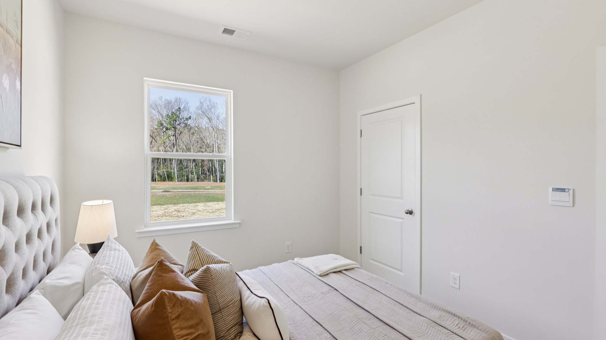 Carpeted bedroom with small window