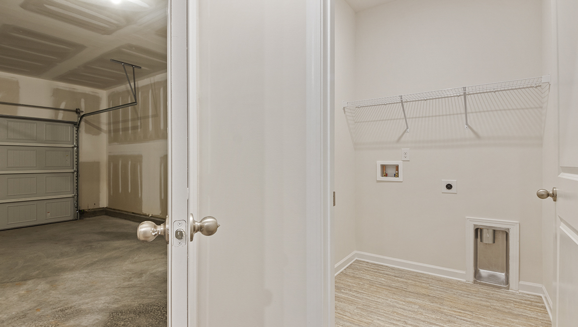 Laundry room with built in racks above the machines