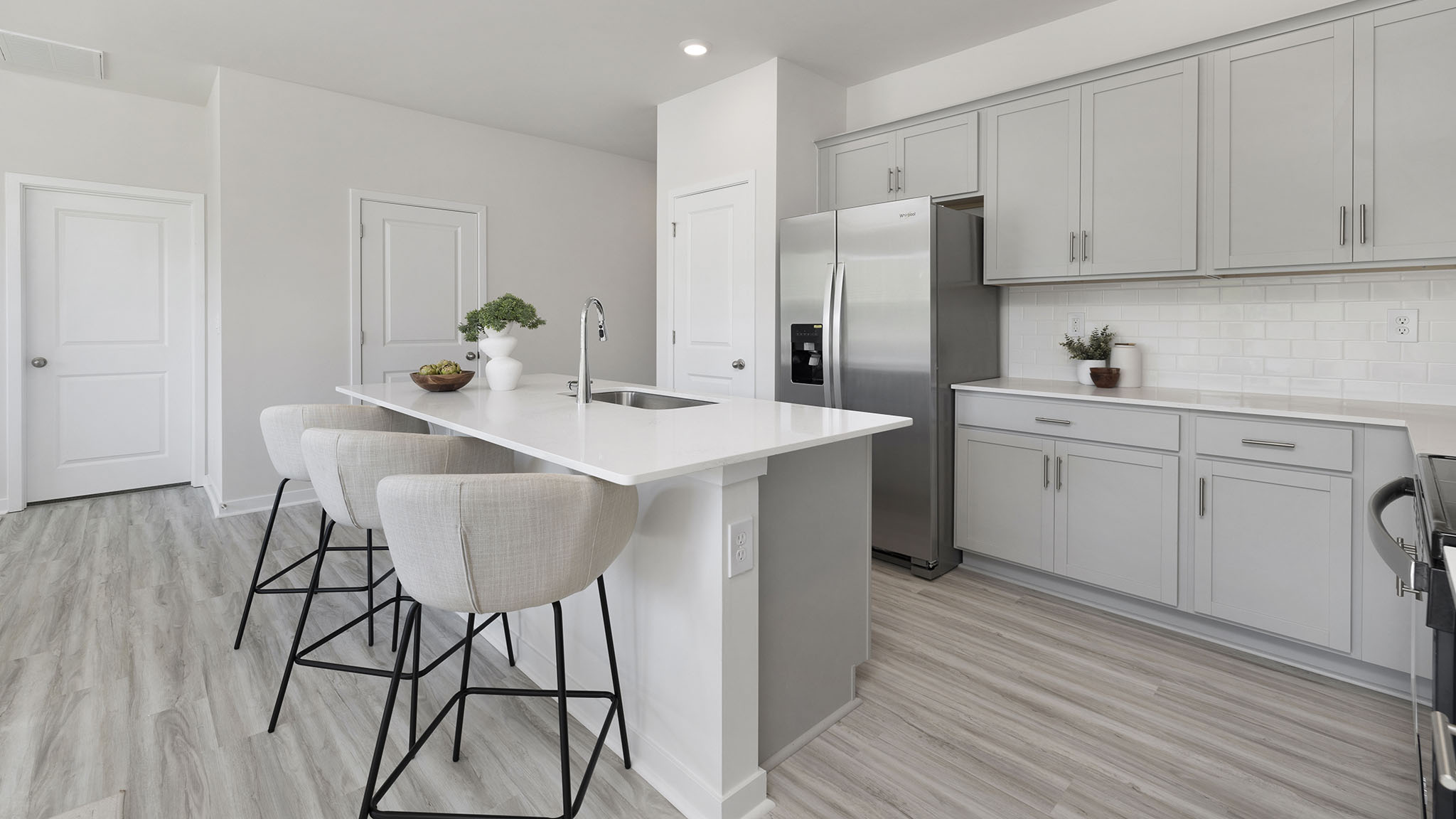 Open kitchen and island with white cabinets