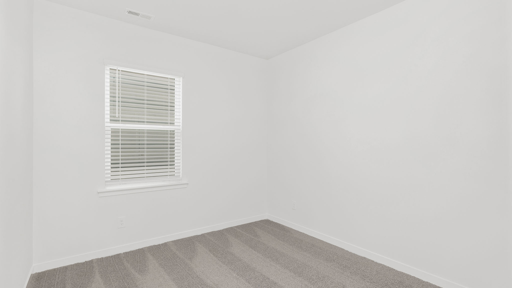 Carpeted bedroom with large window