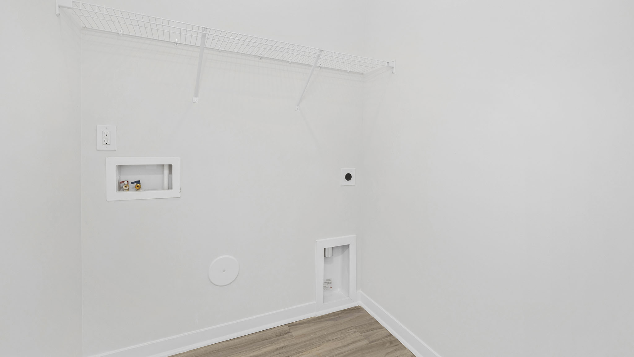 Laundry Room with racks above machines