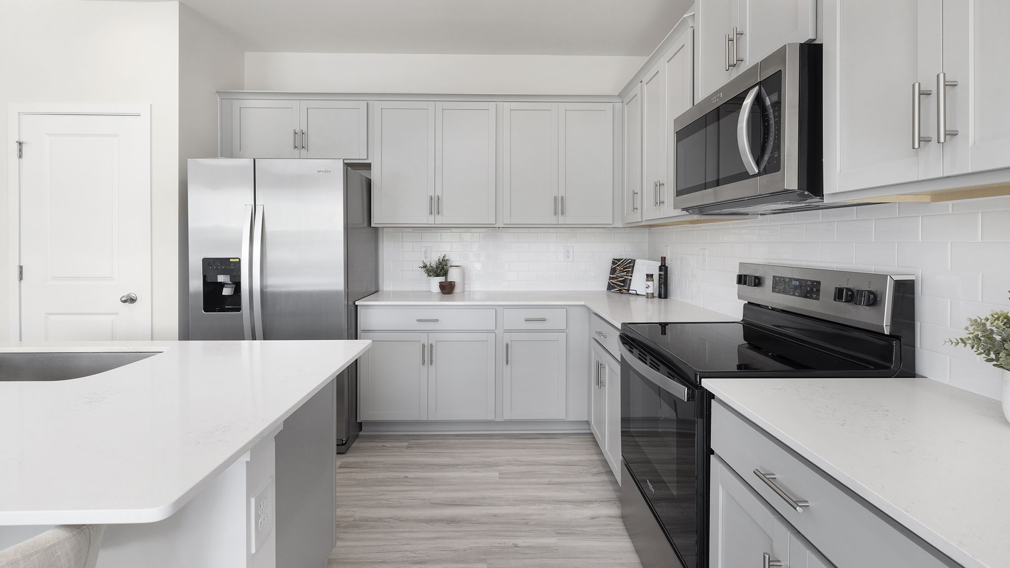 Open kitchen and island with white cabinets