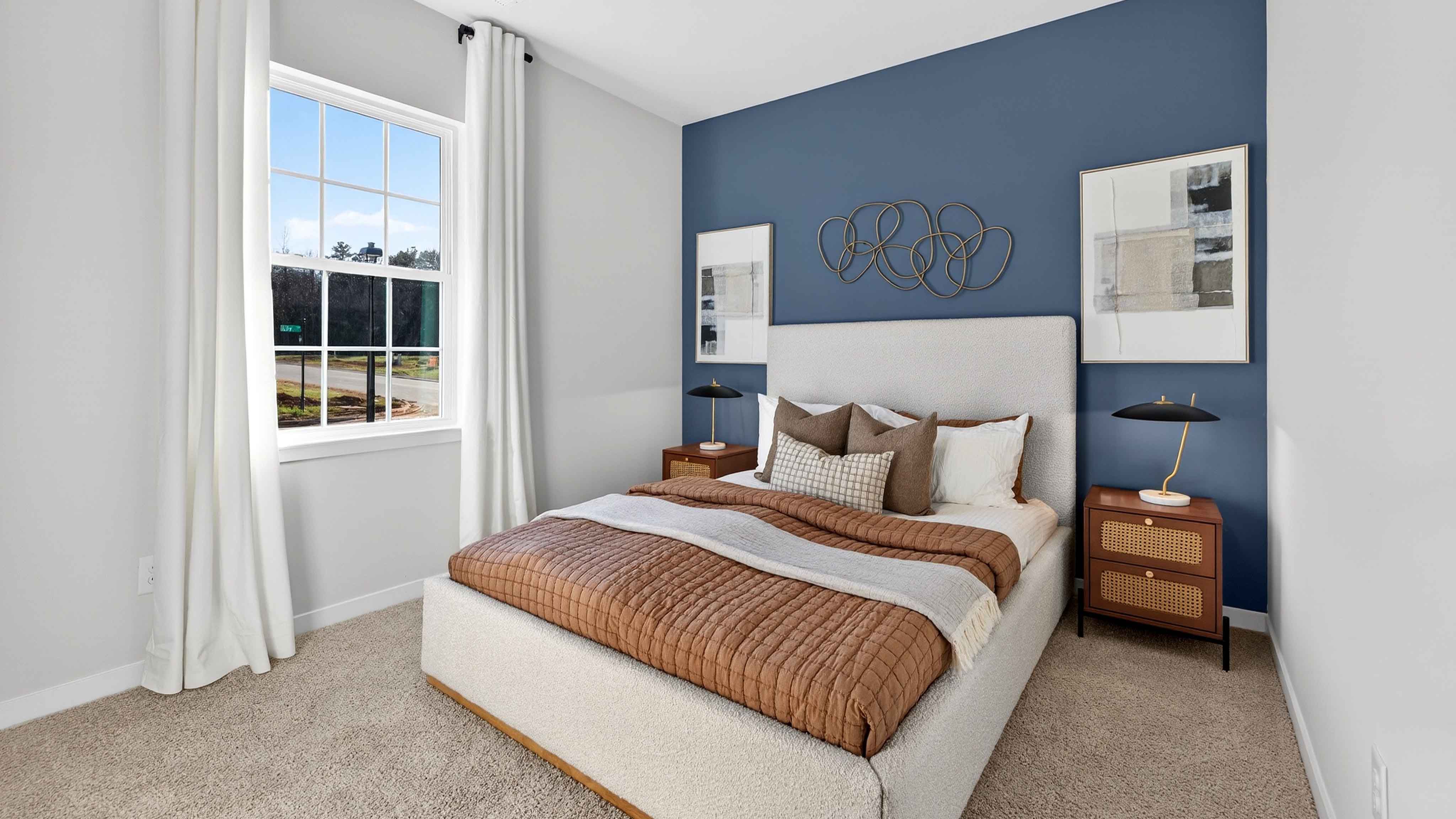 Carpeted bedroom with large window